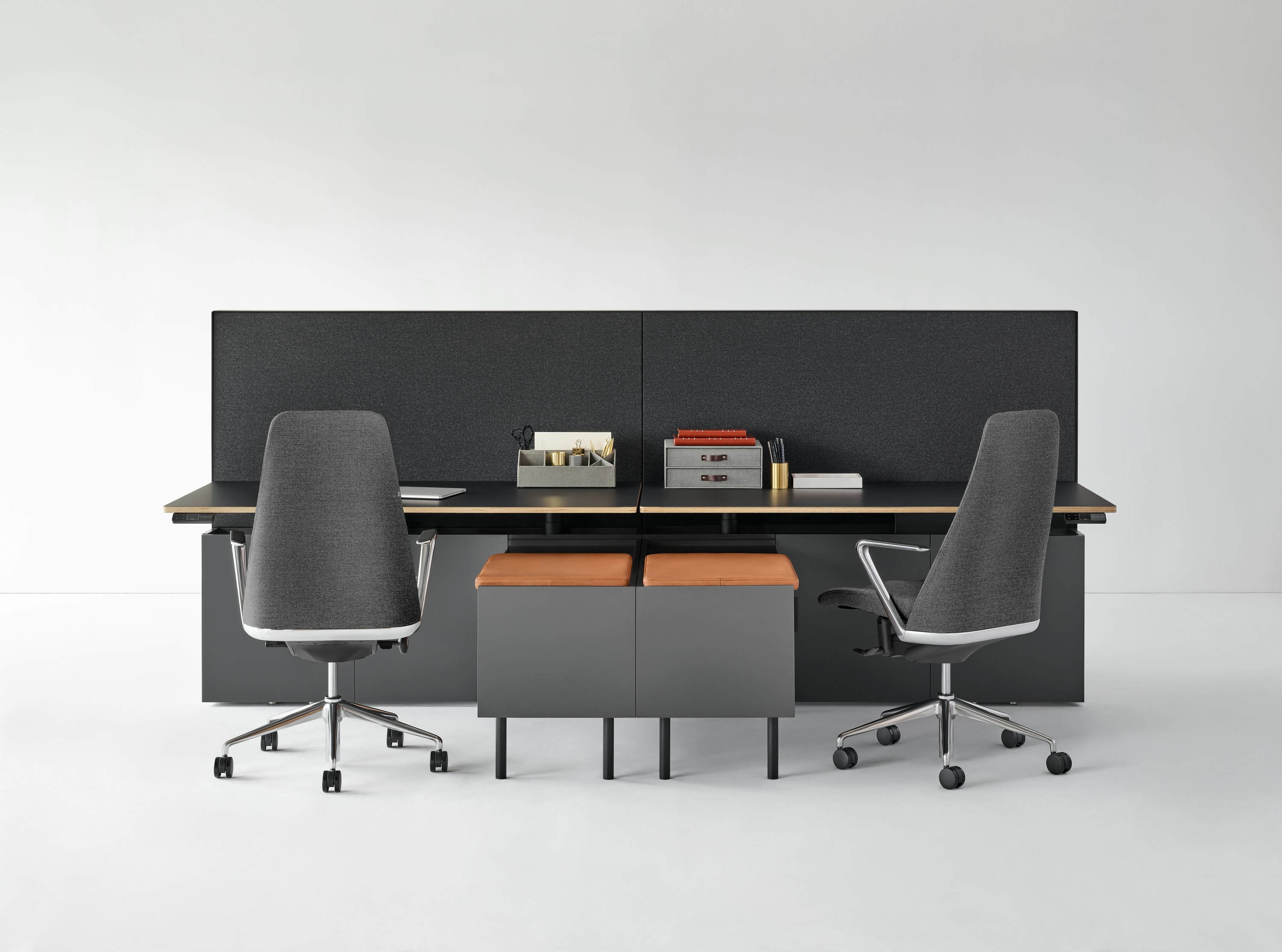 A Geiger One Casegoods bench with accessories, a credenza with a seat pad, and Taper Chairs.