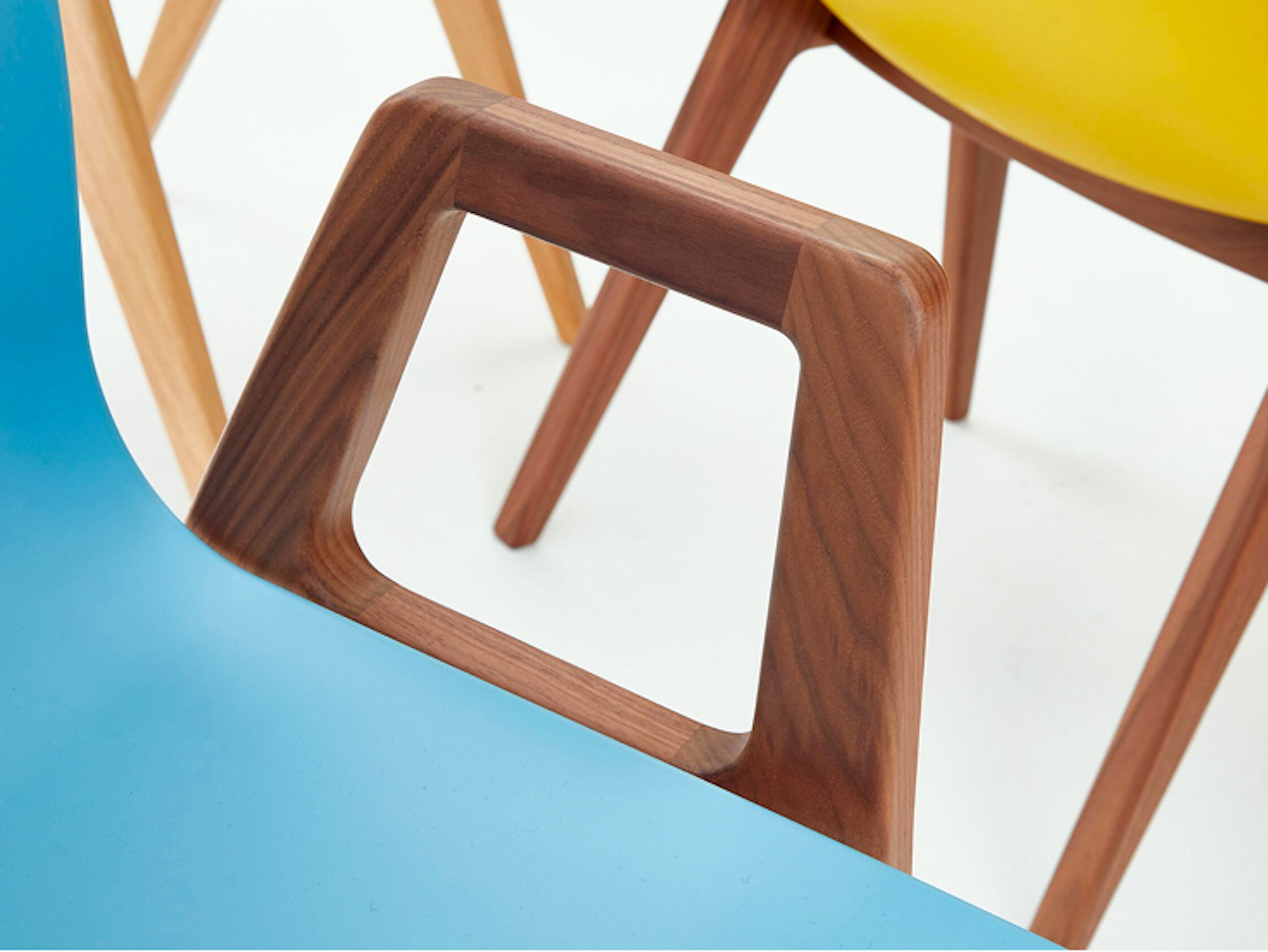 A close up of a blue and a yellow Polly Chair from NaughtOne