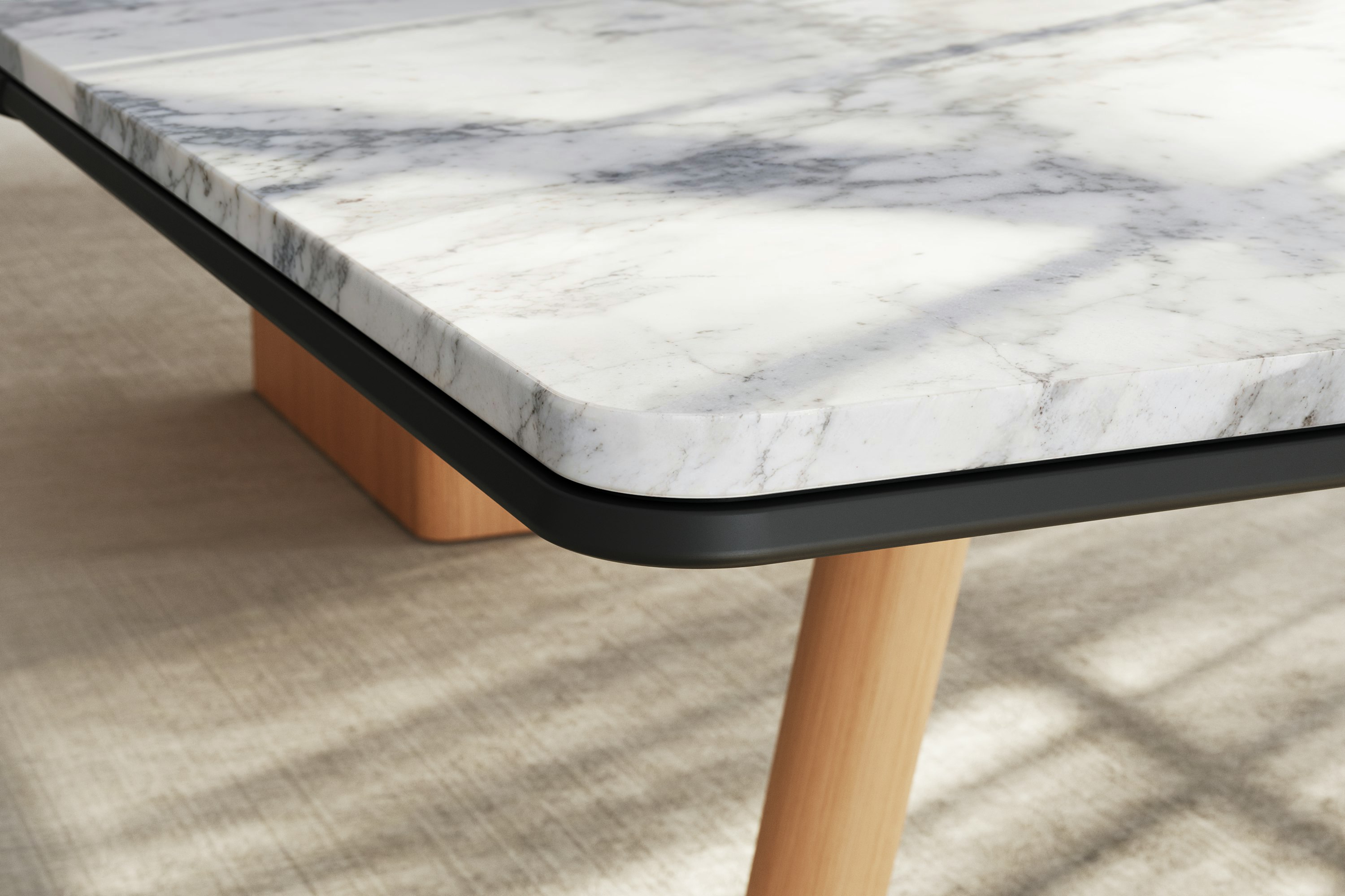 Detail of Ascent Conference Table by EOOS showing protective edge in White Carrara marble with natural rift cut oak base viewed at an angle.