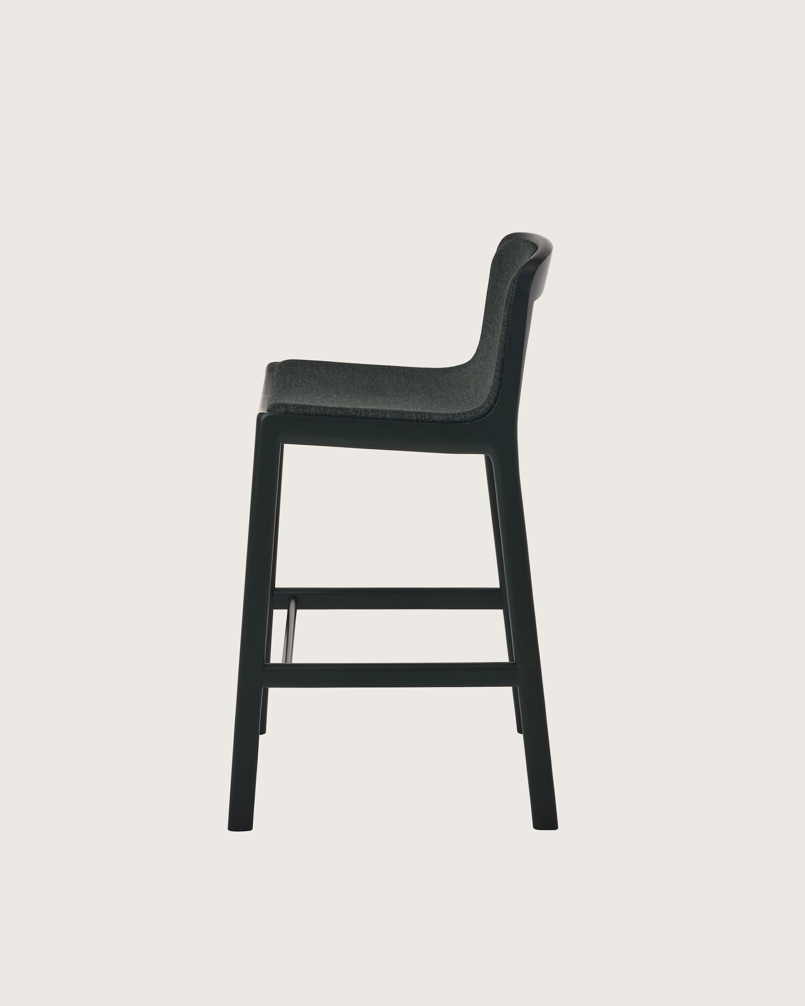 Lijn Stool by Carole Baijings for Geiger in Ivy frame upholstered with Bellano in Black Green, side view on a white sweep.