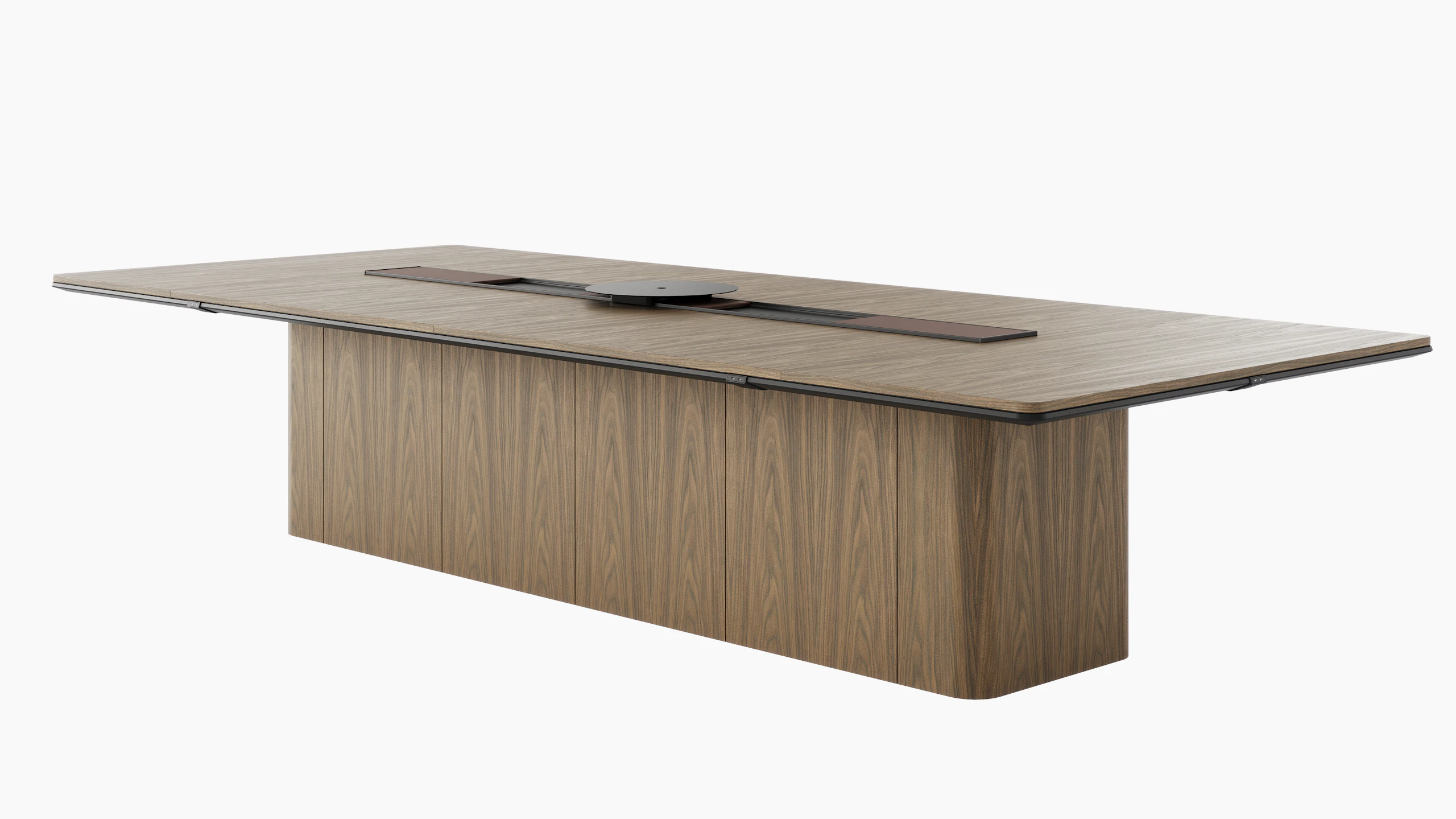 60"x144" Ascent Conference Table designed by EOOS in Natural Flat Cut Walnut with a plinth base, central power trough, an AV platform, and accessory trays, viewed at an angle.