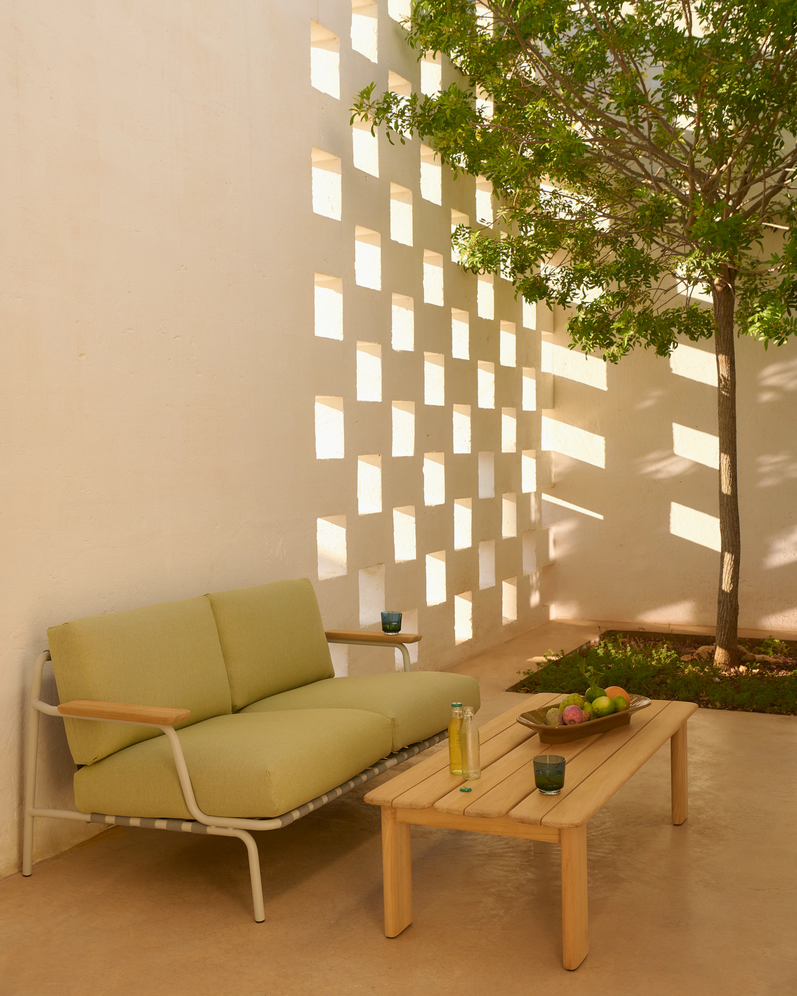 An environmental shot of the Settle Sofa in Grey.