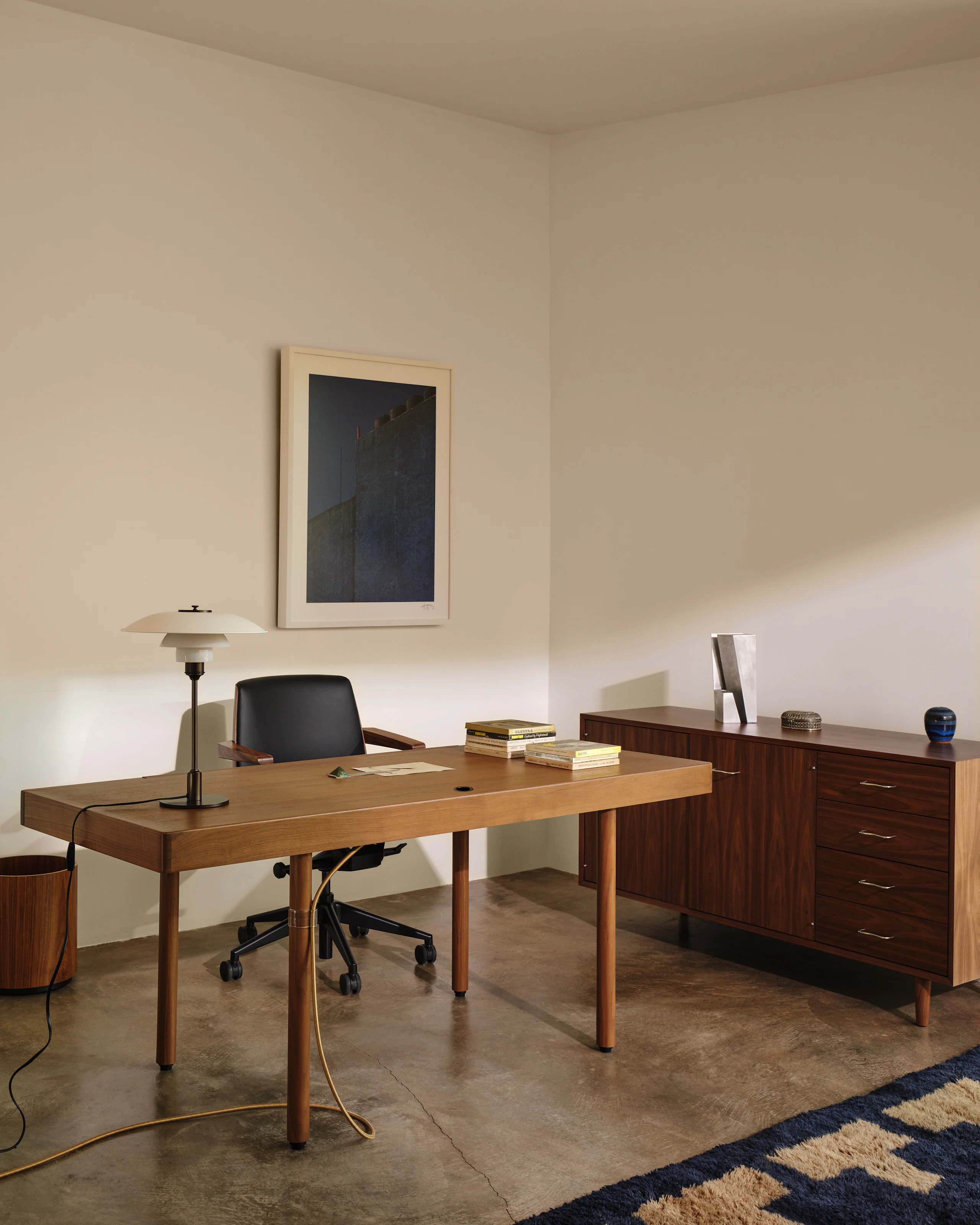 New Canaan Height-Adjustable Desk by BassamFellows in Natural Walnut, with a Clamshell Chair and Nelson Basic Cabinet Series in a residential office setting.