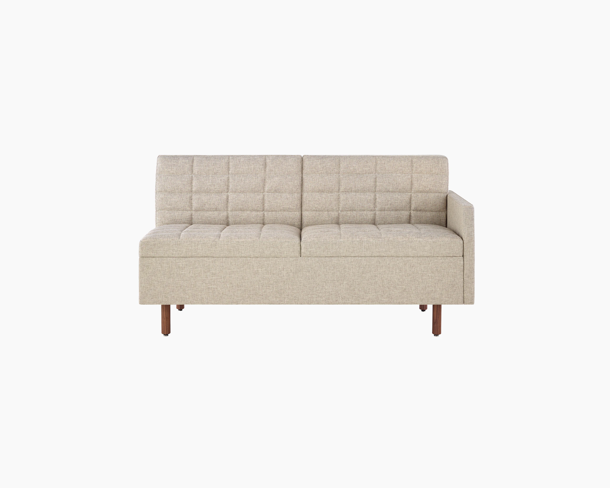 A quilted Tuxedo Classic connecting settee upholstered in bone-colored fabric, viewed from the front.