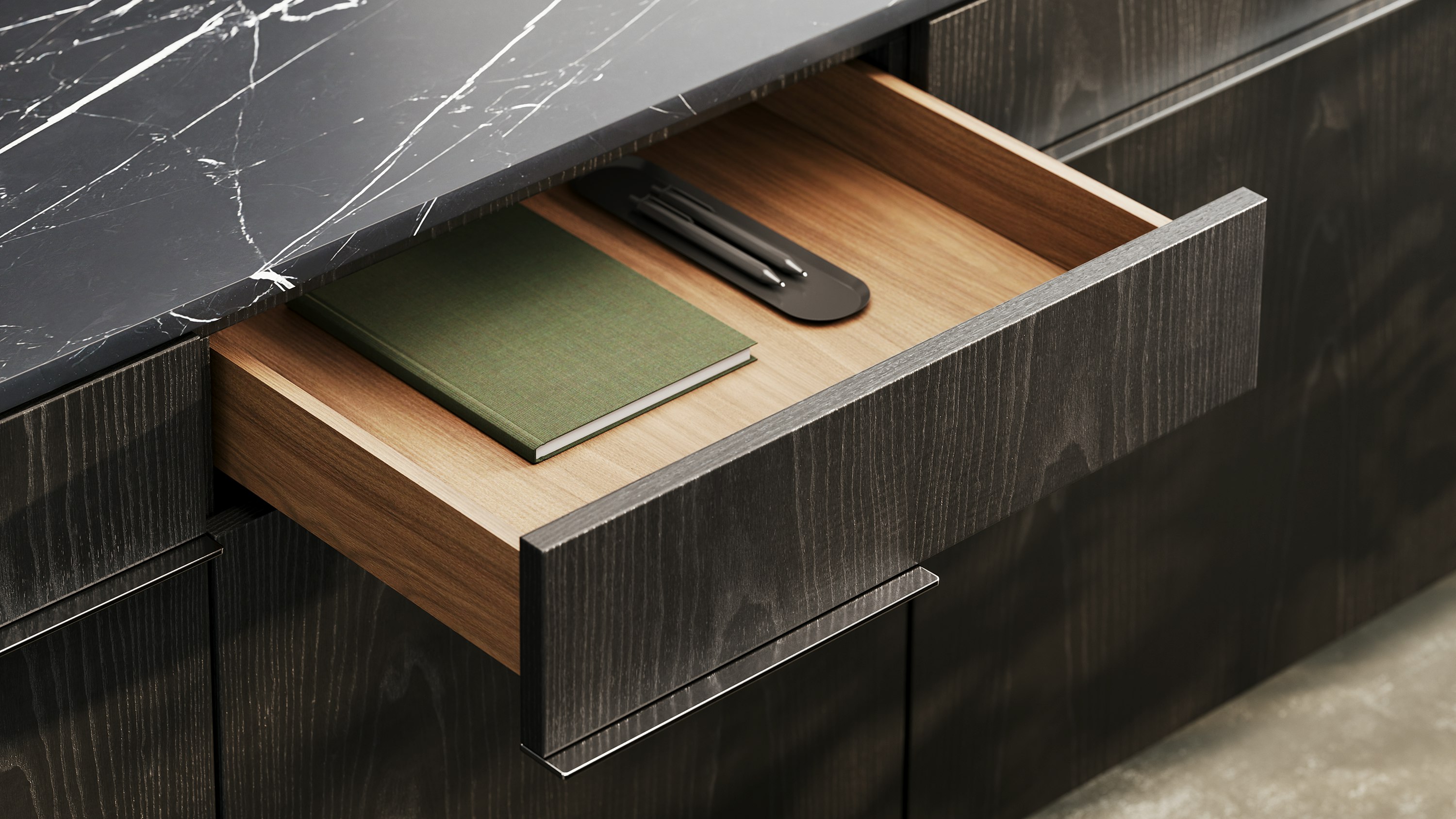 Detail shot of Ascent Credenza designed by EOOS in Ebonized Ash with a Nero Marquina marble top showing the drawer interior.