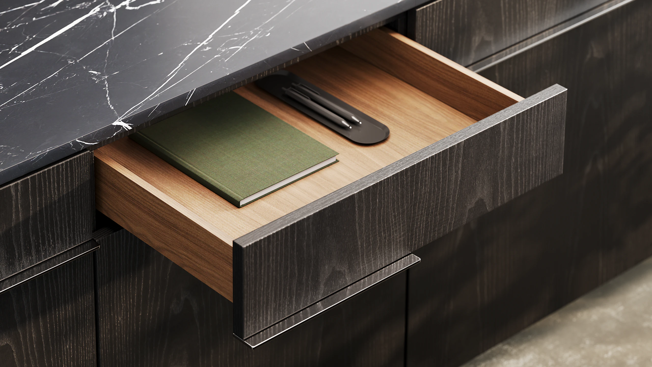 Detail shot of Ascent Credenza designed by EOOS in Ebonized Ash with a Nero Marquina marble top showing the drawer interior.