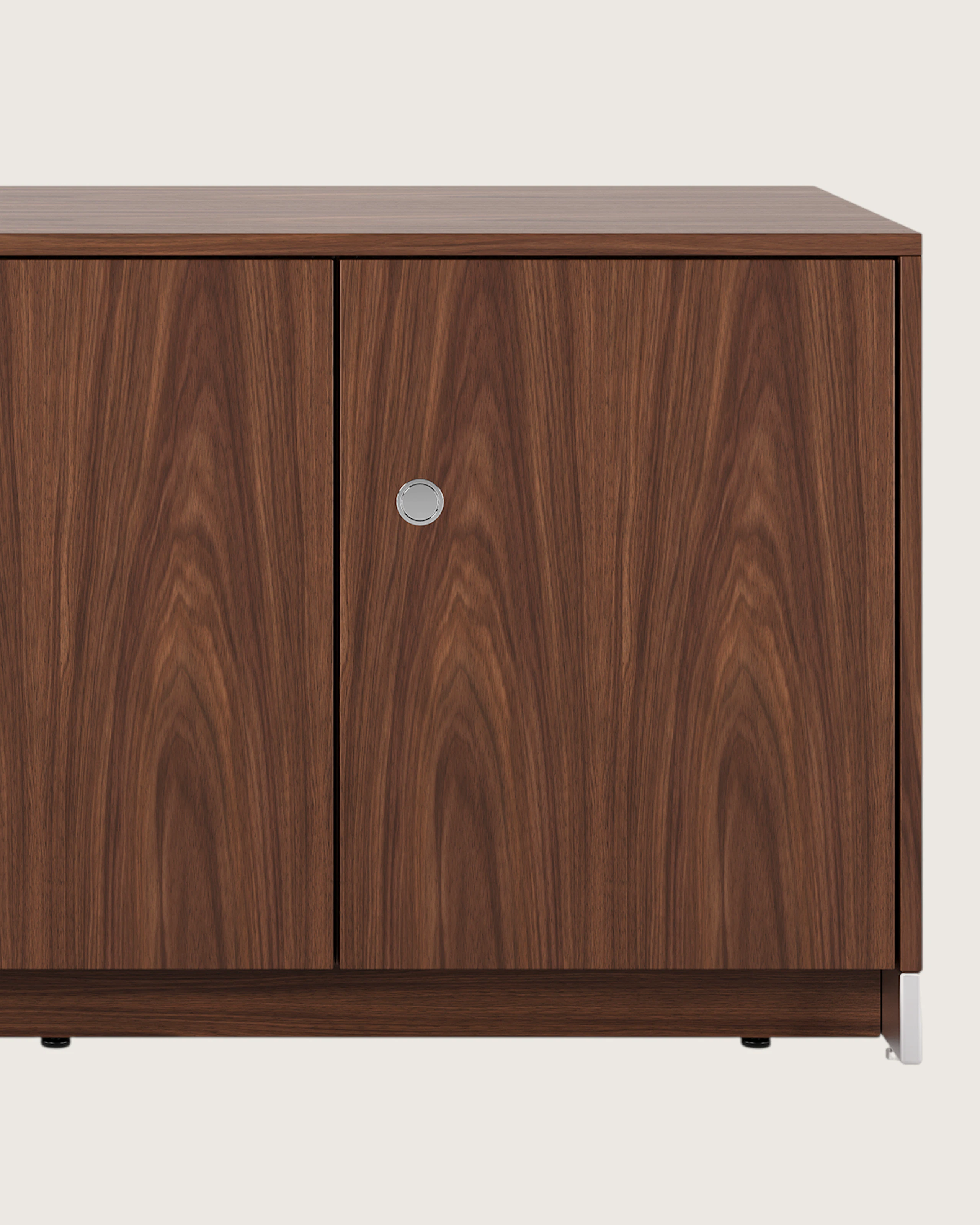 52.5 inch wide Sled Base Credenza with shelf storage in walnut with a chrome base and pulls viewed from the front.