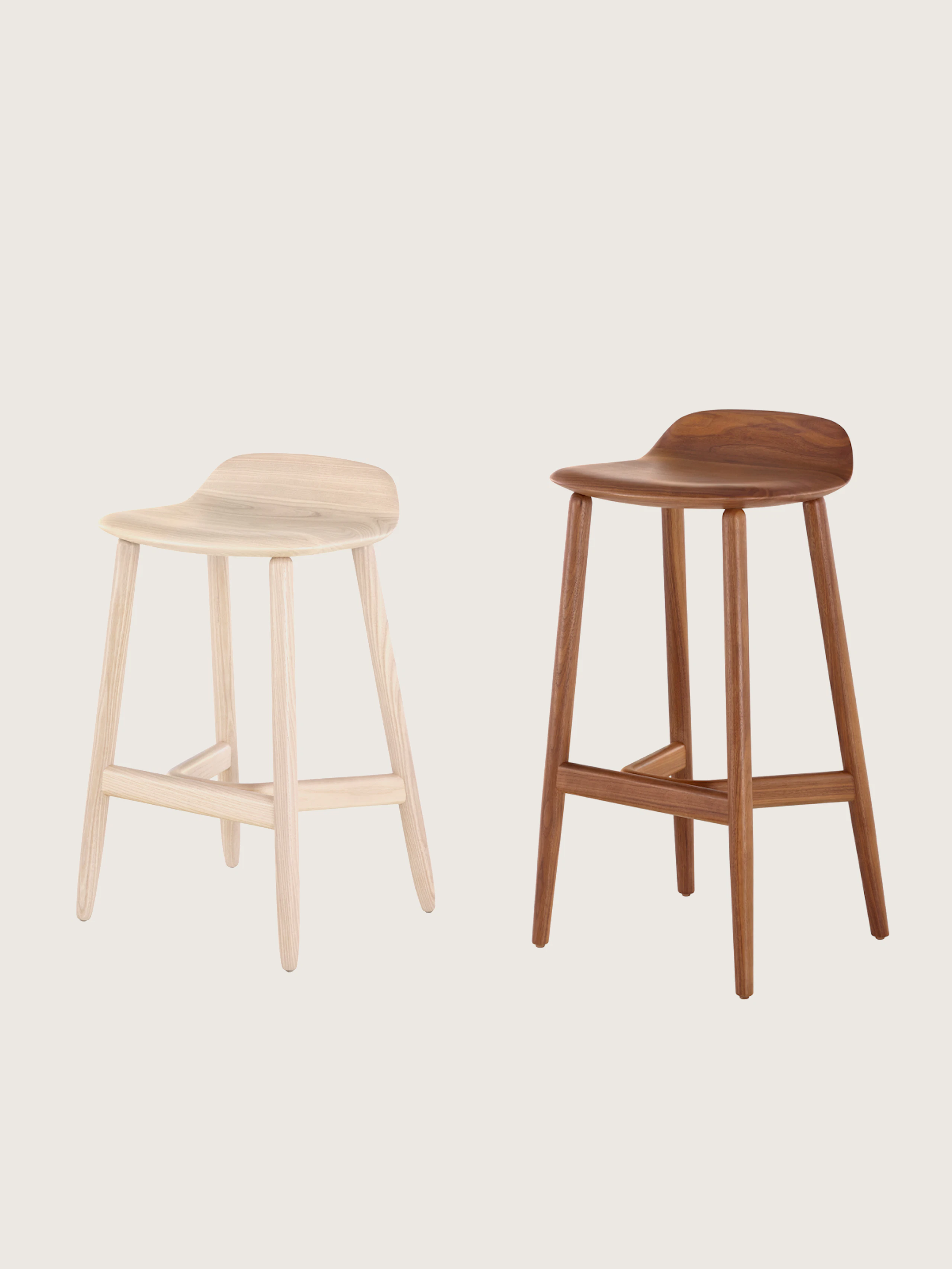 Two Crosshatch Stools designed by EOOS, one counter-height in Oak, one bar-height in walnut, both shown at an angle on a white sweep.