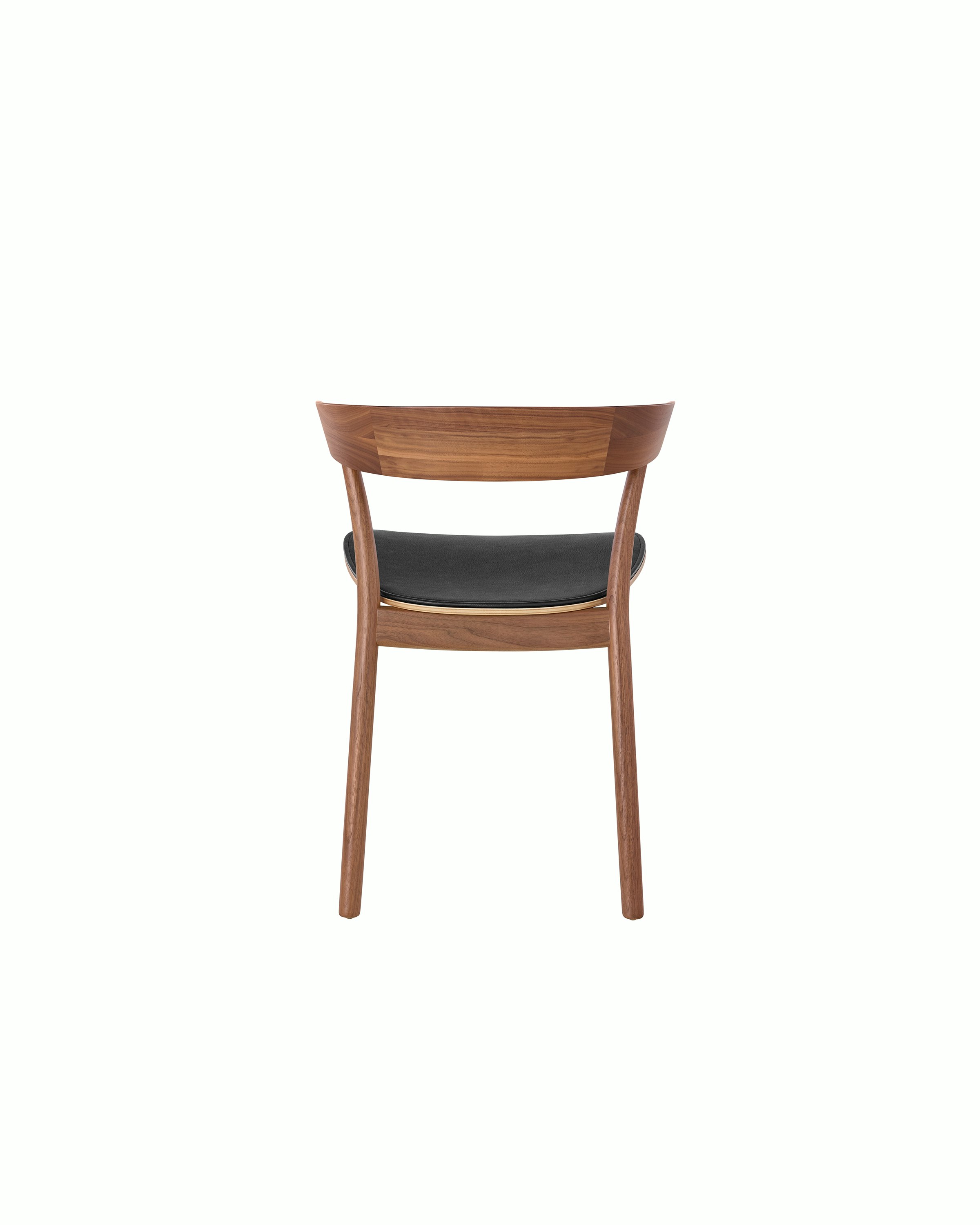A Leeway side chair with a wood frame and backrest in a medium finish and a seat upholstered in black leather, viewed from behind.