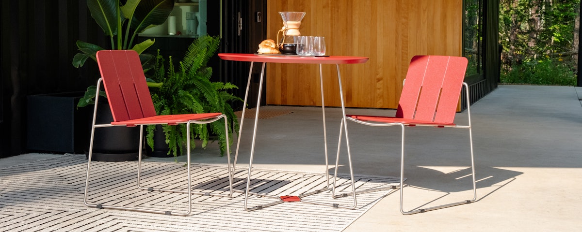 Two Keene Side Chairs and a Keene Dining Table with coffee and pastries in a patio setting