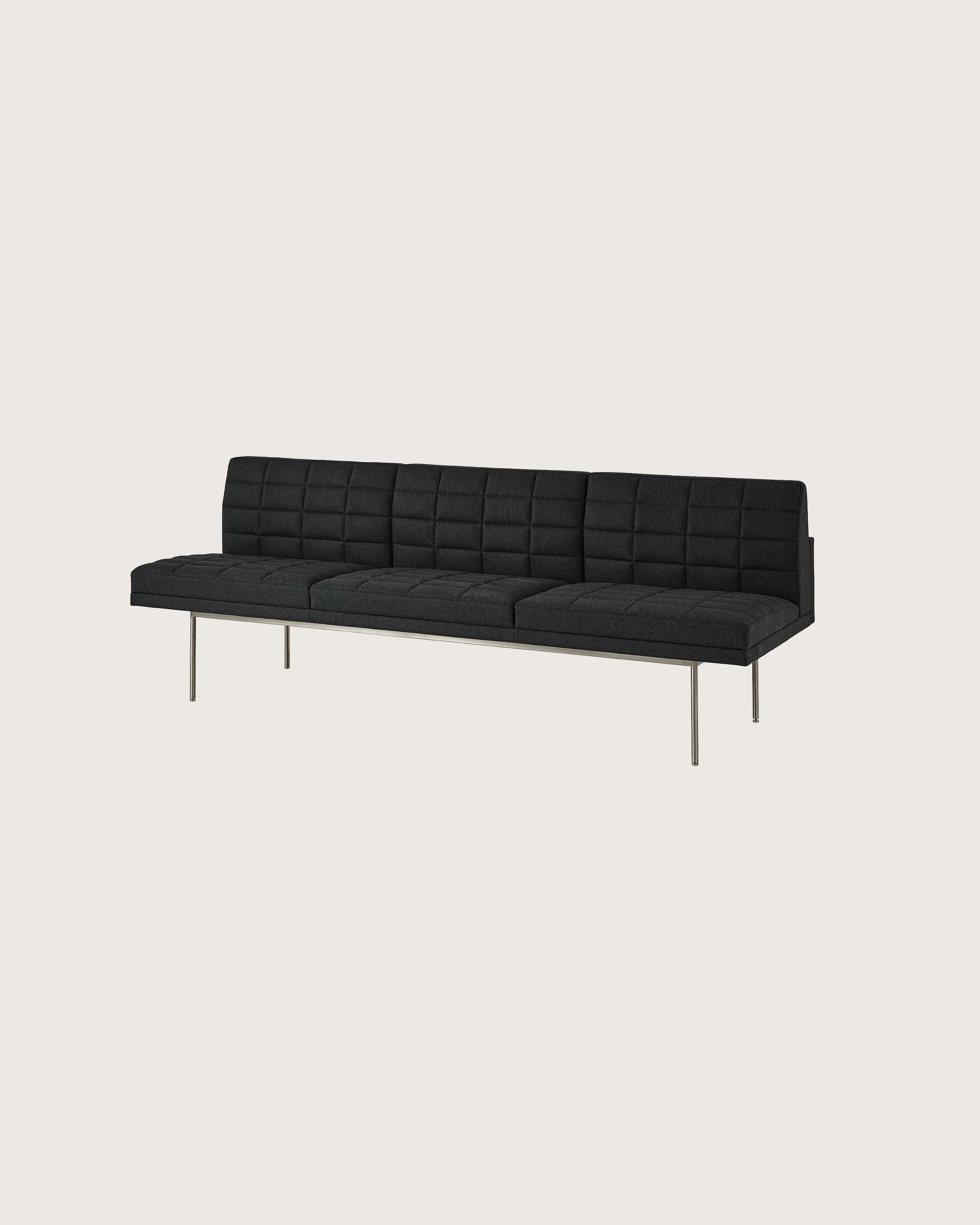 Tuxedo Component Sofa designed by BassamFellows upholstered in Bellano in Charcoal with a polished chrome base, shown at an angle on a white sweep.