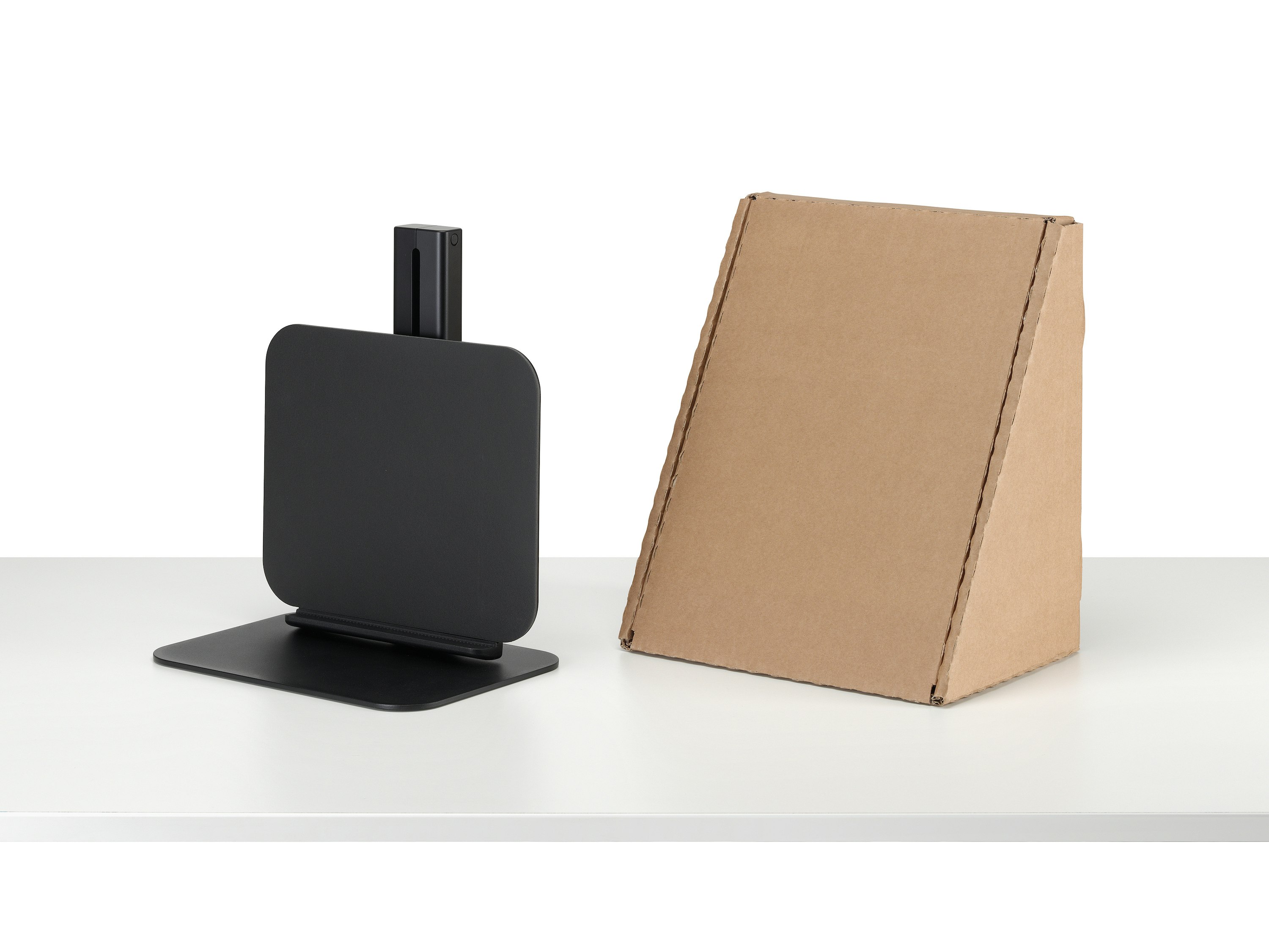 Lana laptop stand in black and packaging viewed from a sided angle.