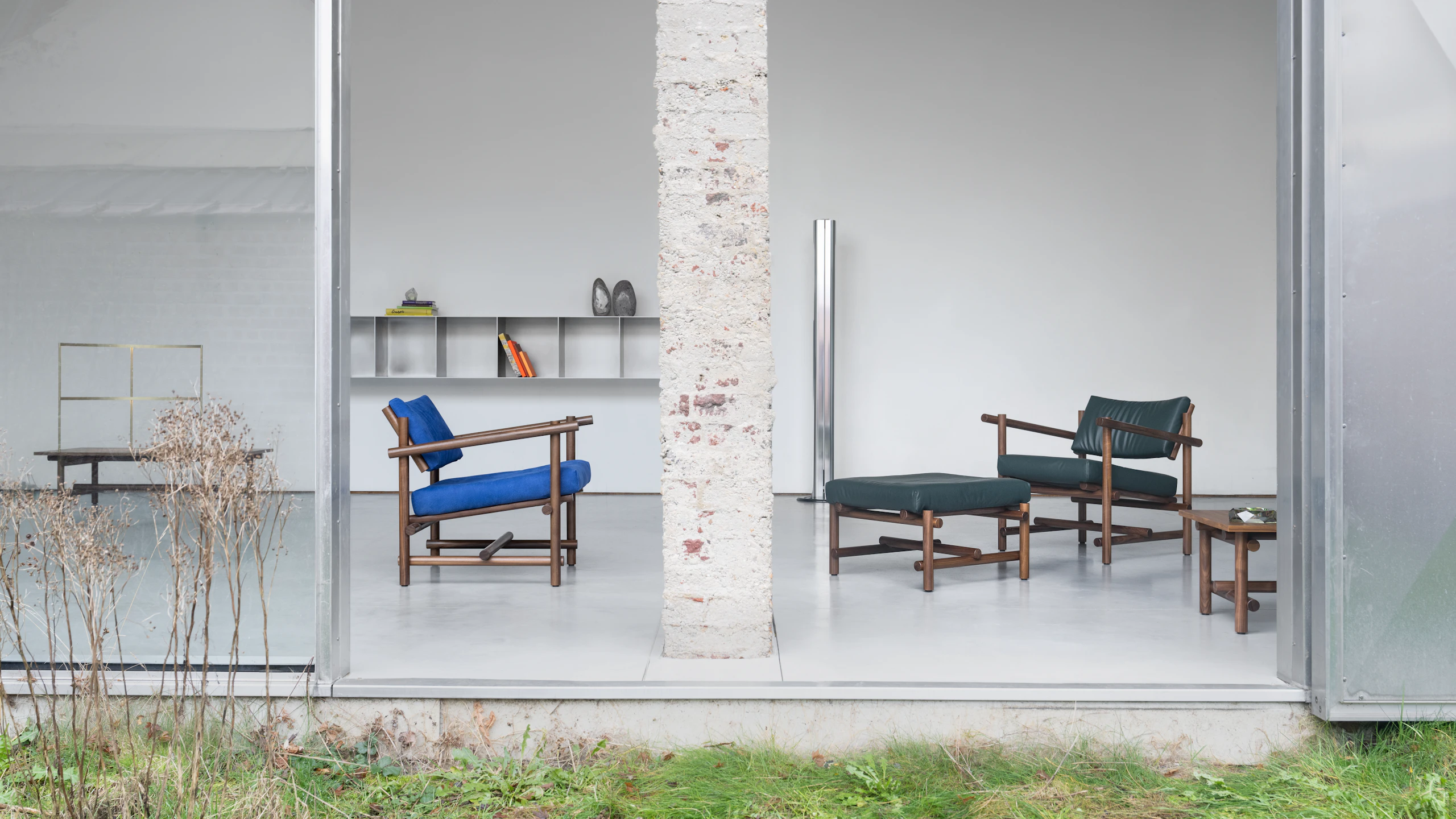 Muecke Lounge Chairs and Ottoman in a white indoor space partially open to the outdoors.