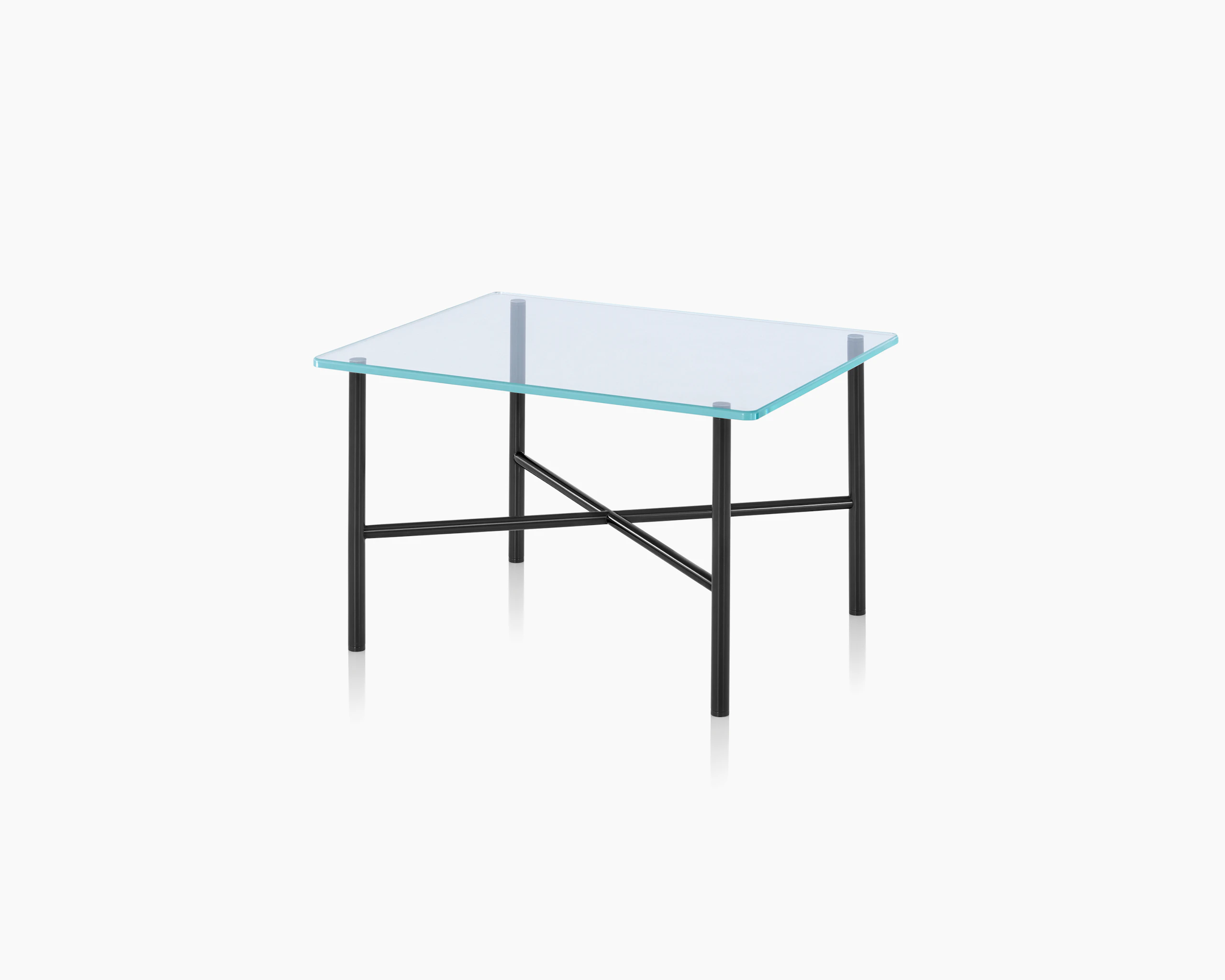 Angled view of a Layer side table with a glass top and black metal cross braces.