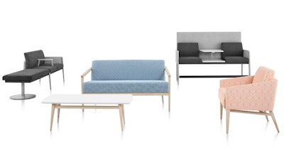 Several pieces of furniture from the Palisade Collection by Herman Miller including a blue sofa, reddish-pink chair, and black and grey benches.