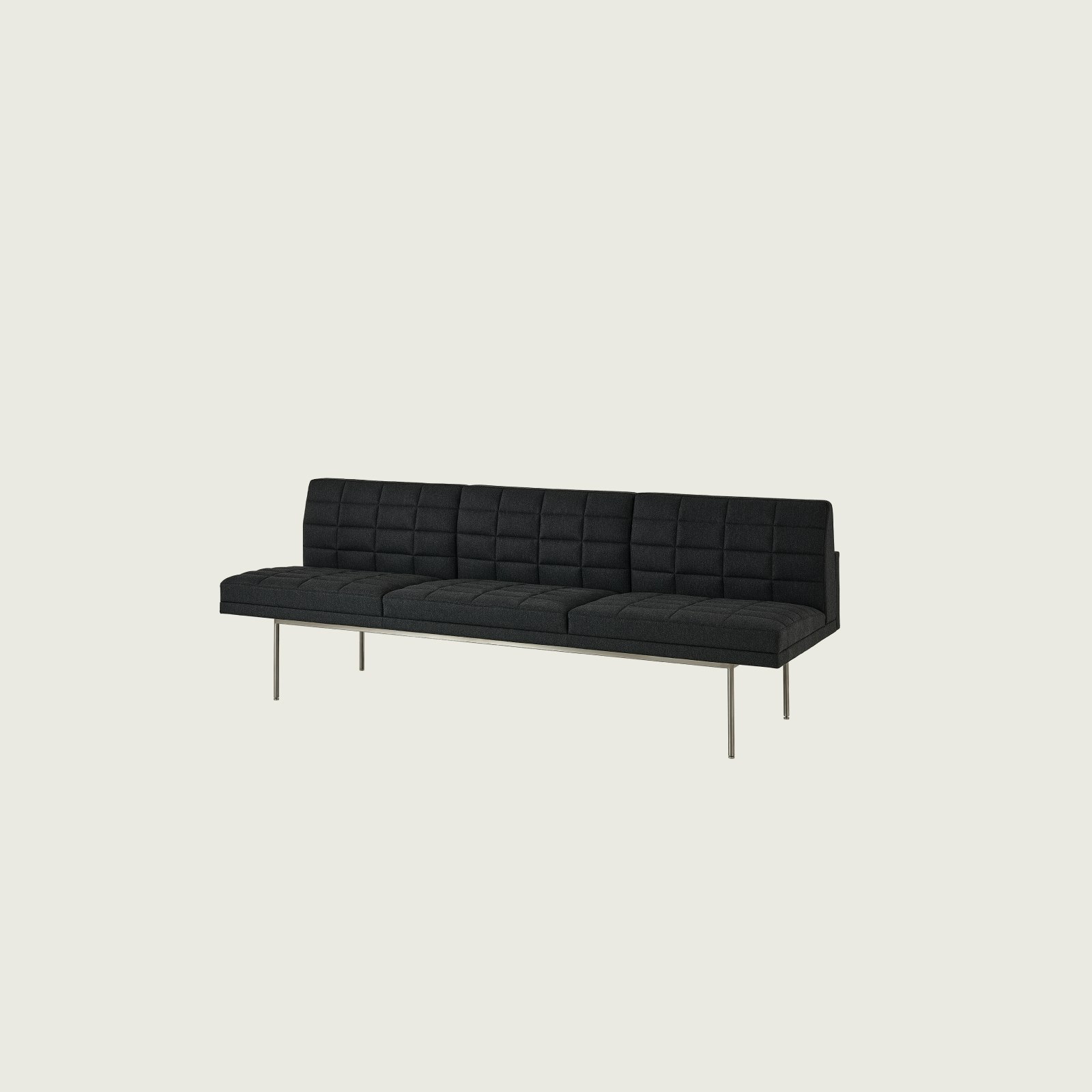 Tuxedo Component Sofa designed by BassamFellows upholstered in Bellano in Charcoal with a polished chrome base, shown at an angle on a white sweep.