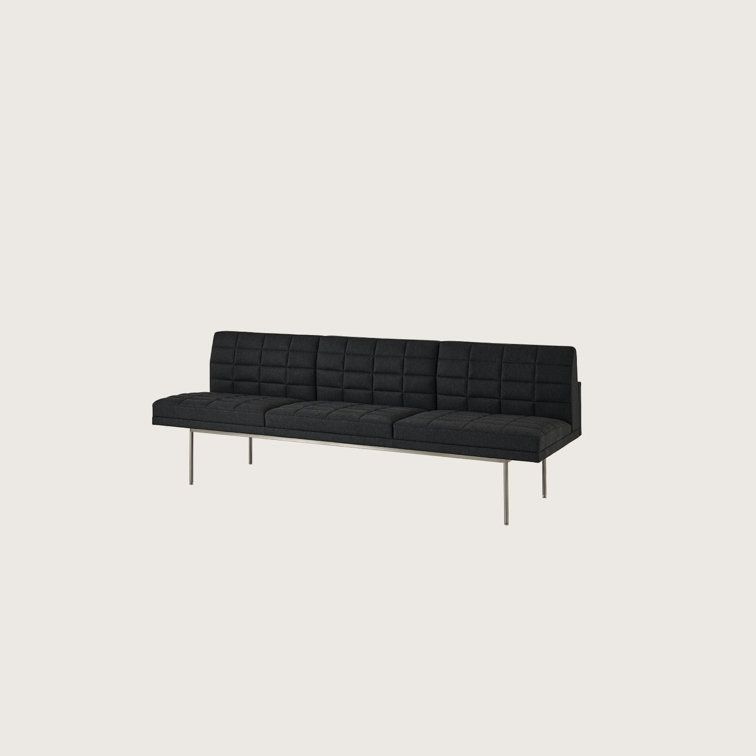 Tuxedo Component Sofa designed by BassamFellows upholstered in Bellano in Charcoal with a polished chrome base, shown at an angle on a white sweep.