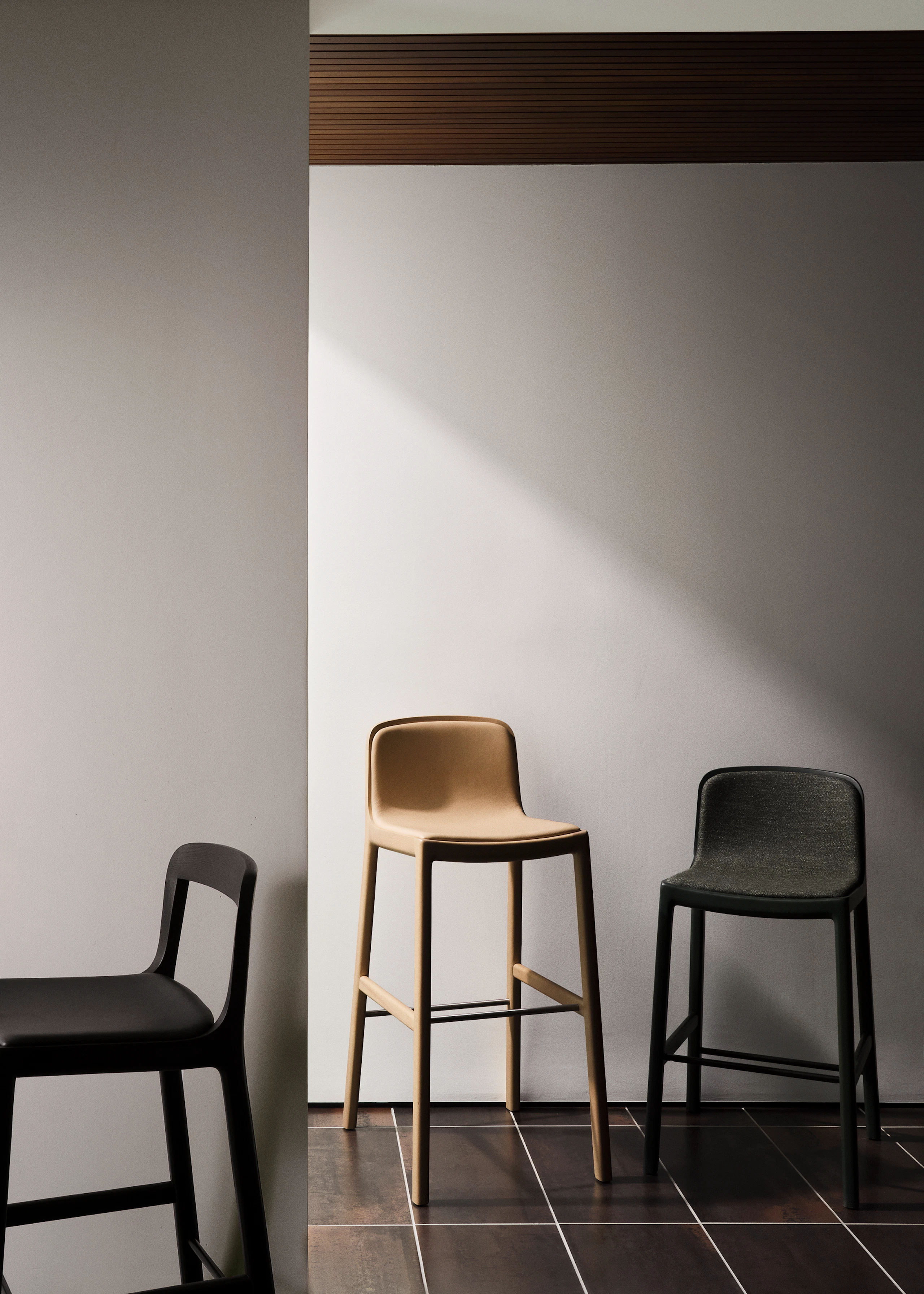Lijn Stools in Bar and Counter-Heights designed by Carole Baijings for Geiger in a variety of wood stains, textiles, and leather upholsteries.