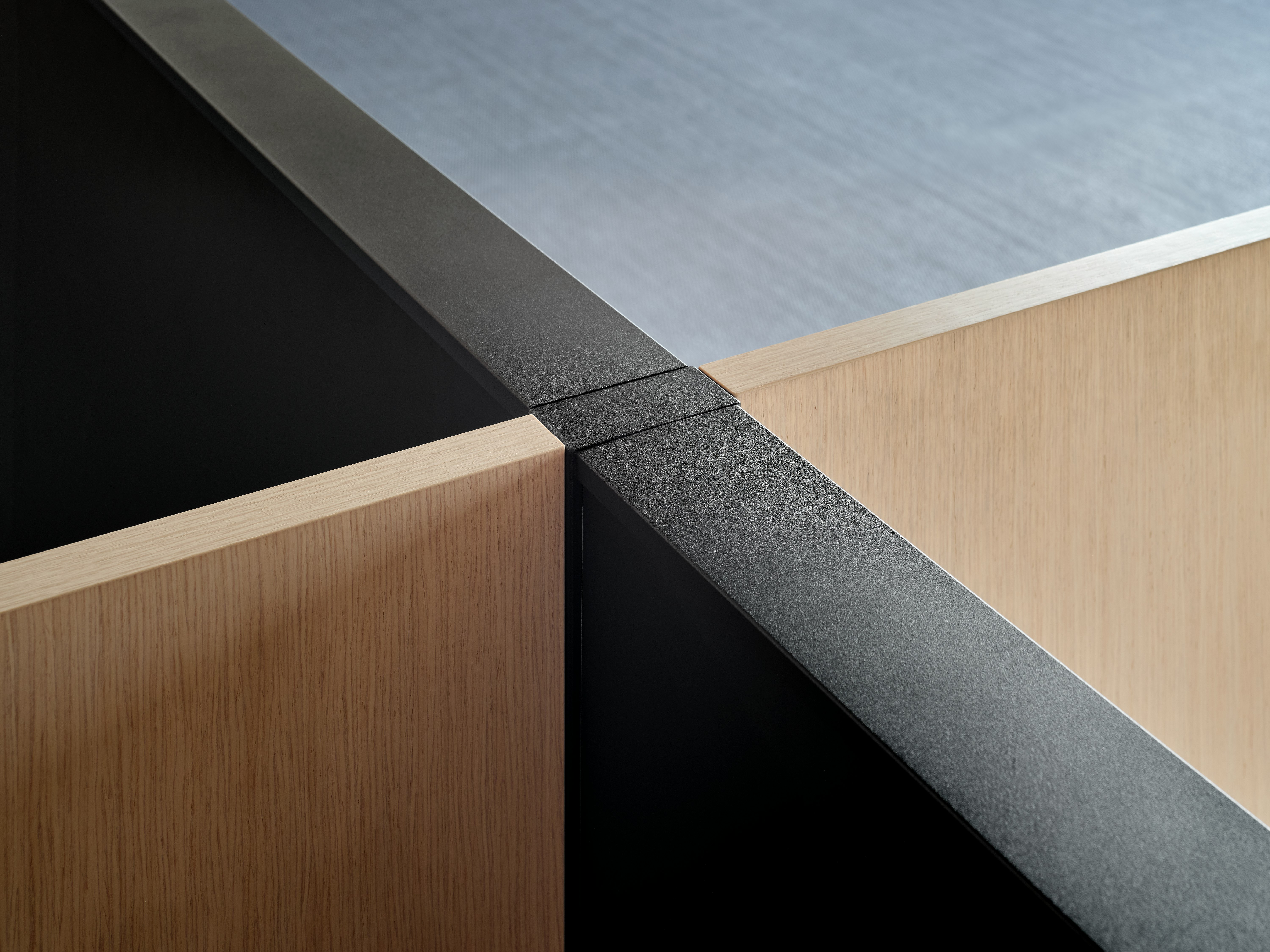 A detail image of Skyline system panels joining with freestanding or desk mounted screens at a perpendicular angle.