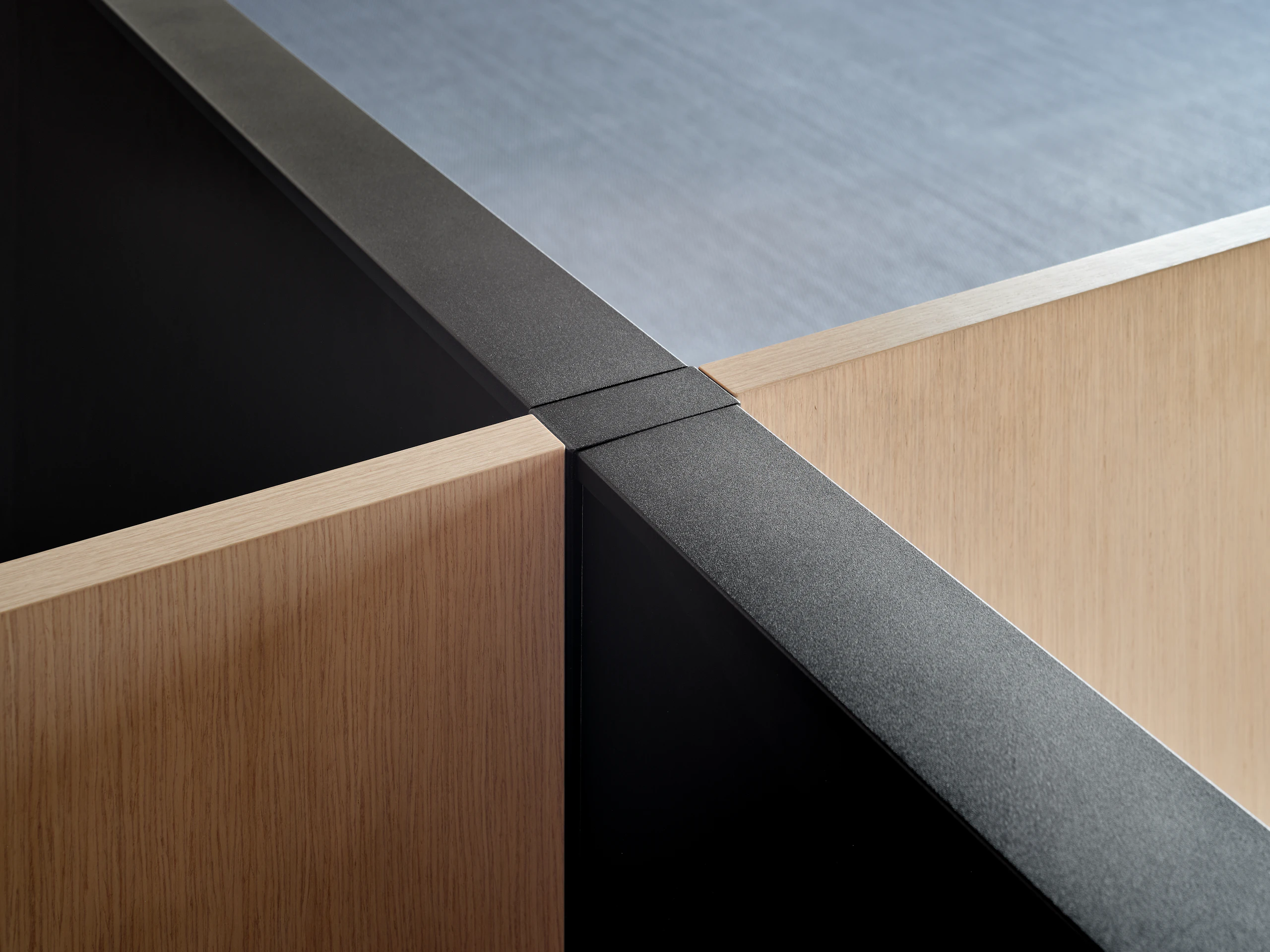 A detail image of Skyline system panels joining with freestanding or desk mounted screens at a perpendicular angle.