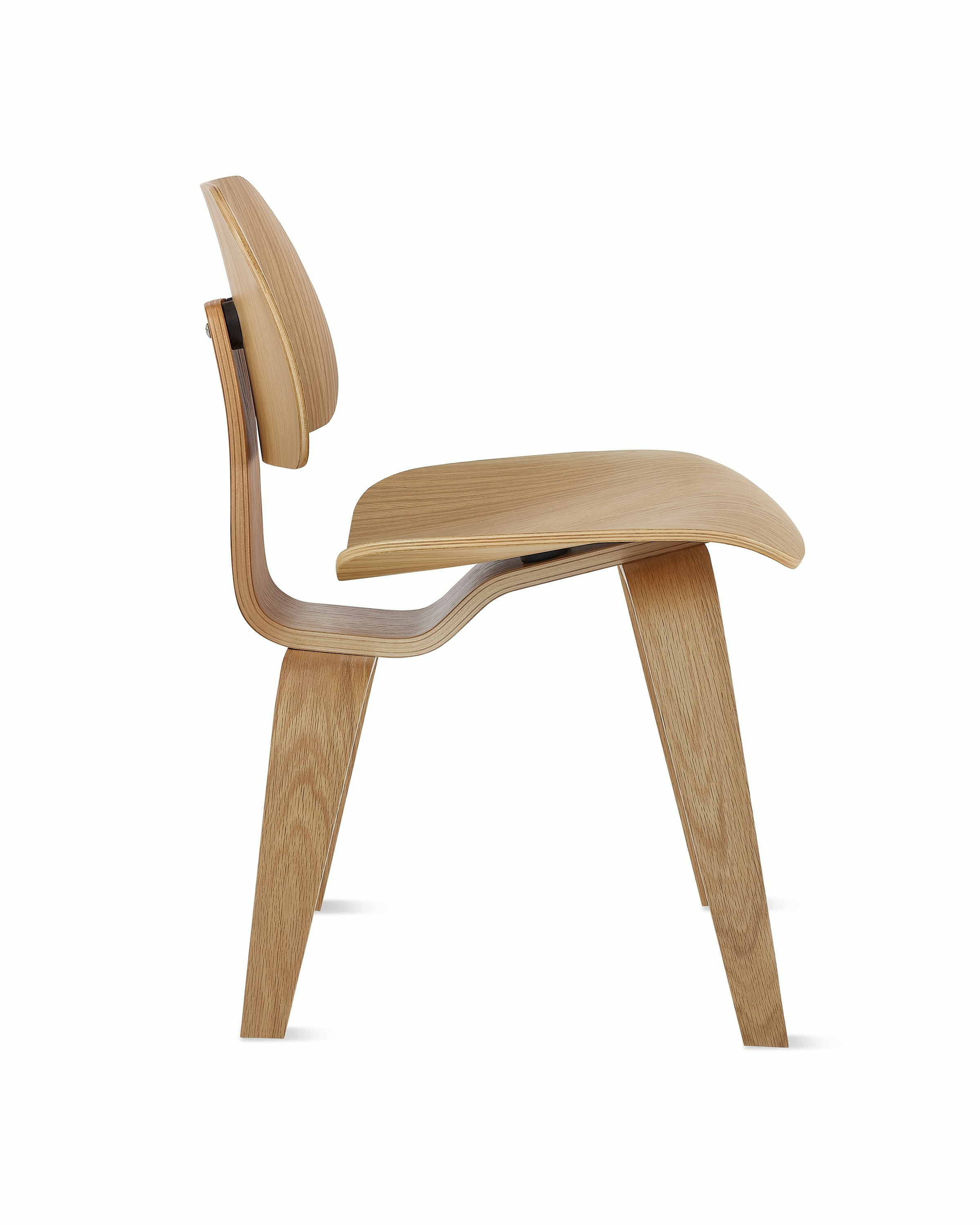 An Eames Molded Plywood Dining Chair in White Oak viewed from the side