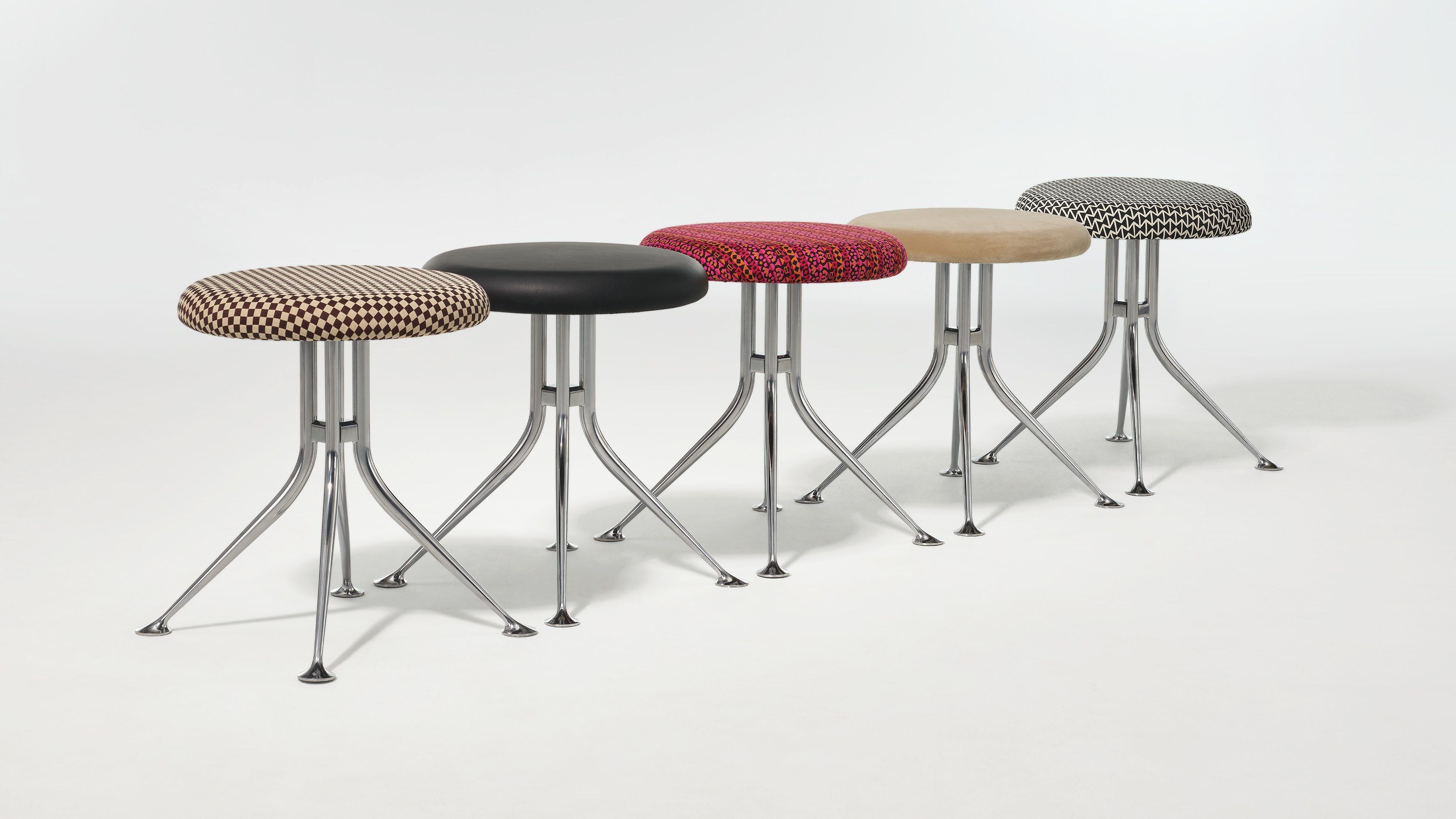 A line of Girard Stools showing the variety of upholstery options.