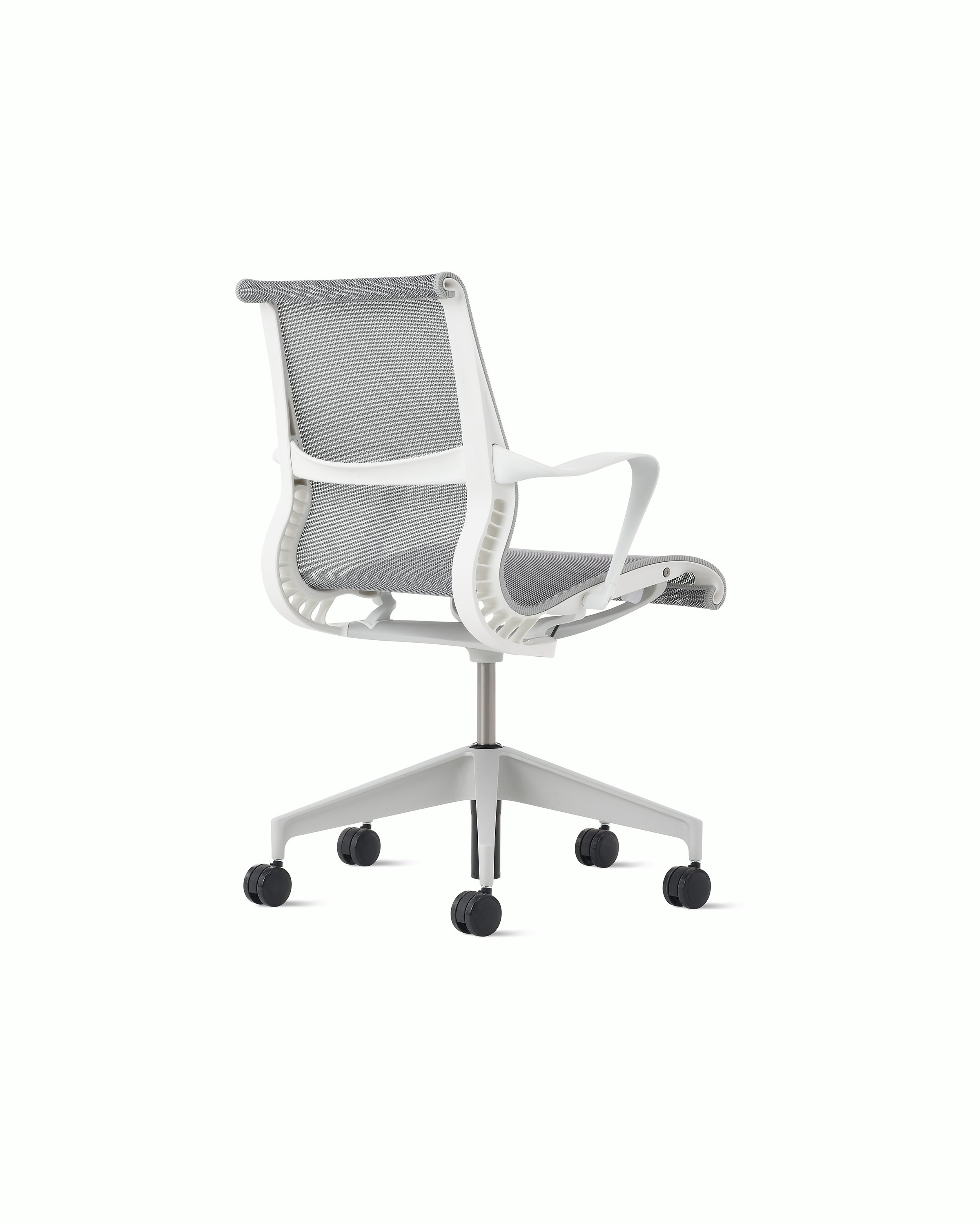 Rear angle view of a Setu chair with grey suspension, white frame and silver alloy base.