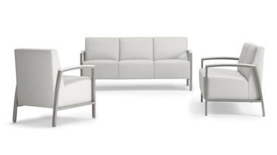Several pieces of white furniture from the Brava Collection by Herman Miller including a chair, two seat sofa, and three seat sofa.