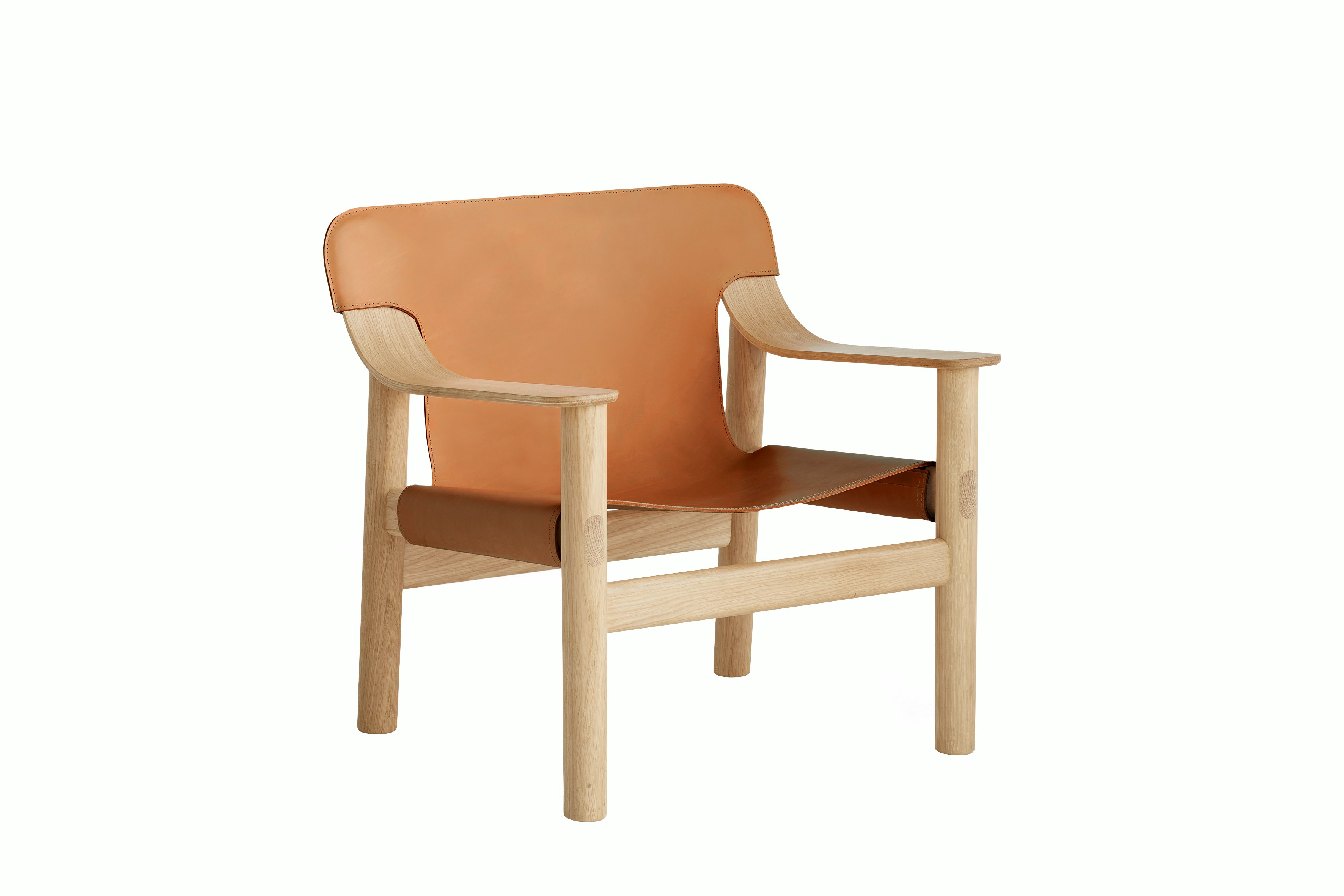 A front angle view of the Bernard Lounge Chair with oak frame and cognac leather seat and back.