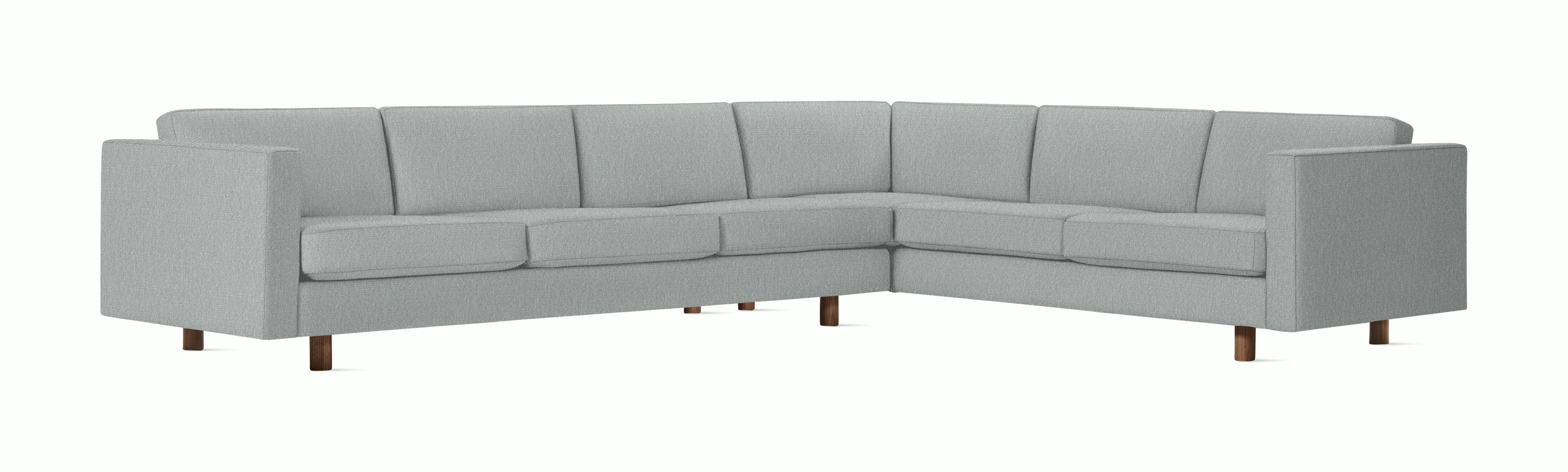 A Lispenard Corner Sectional in Powder with Walnut finish viewed from the front.