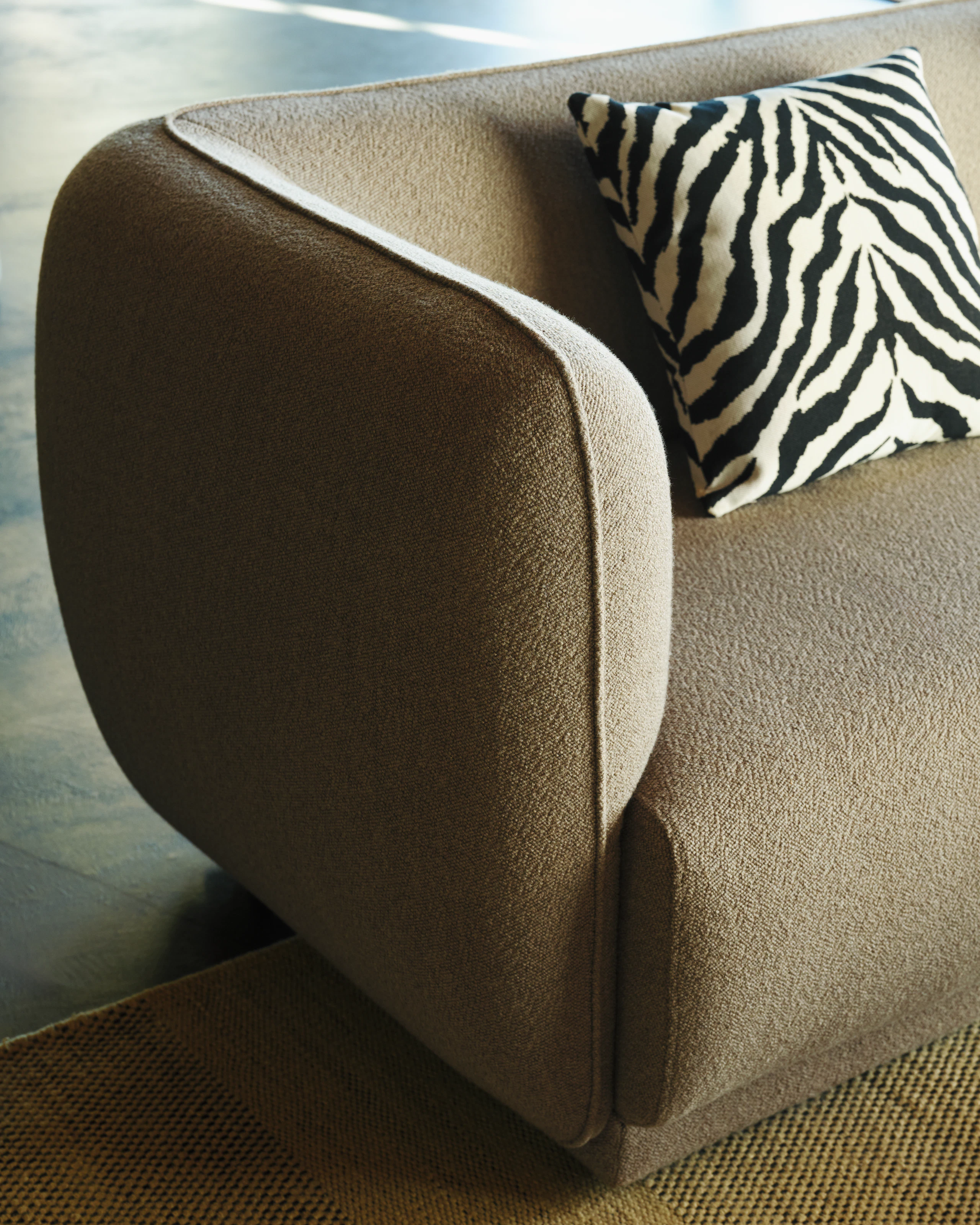 Meris Sofa in Ash Brown turf fabric with Zebra Pillow