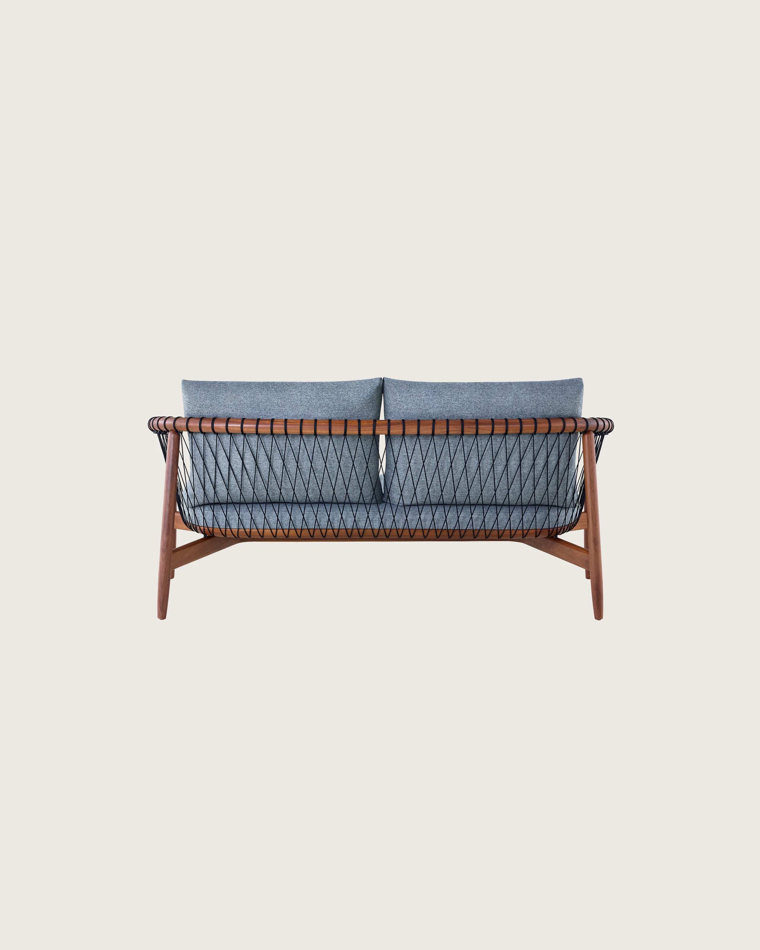A dark-colored Crosshatch Settee featuring gray upholstery and a walnut frame. Viewed from behind.