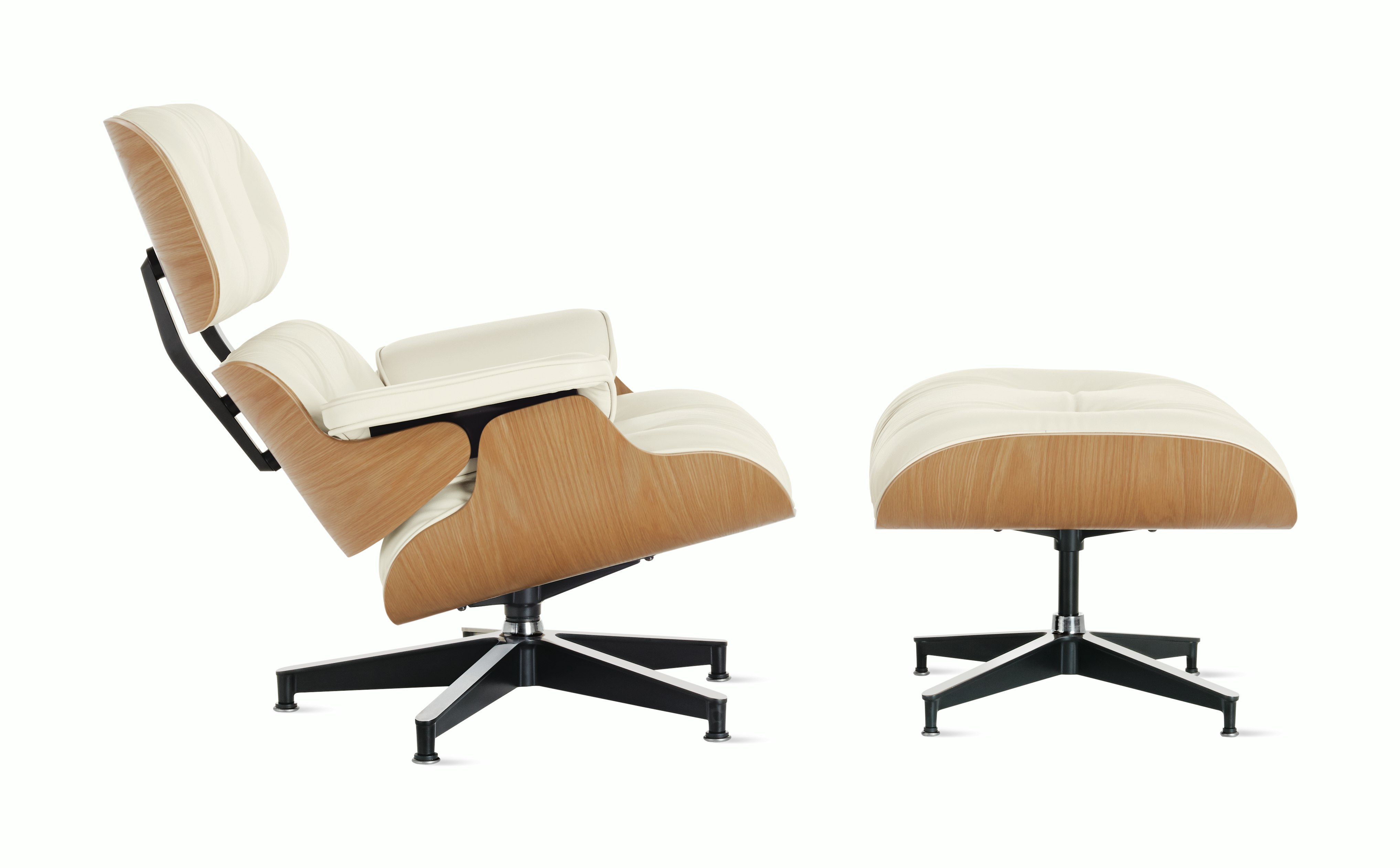 Profile view of an Eames Lounge Chair and Ottoman with white oak veneer.