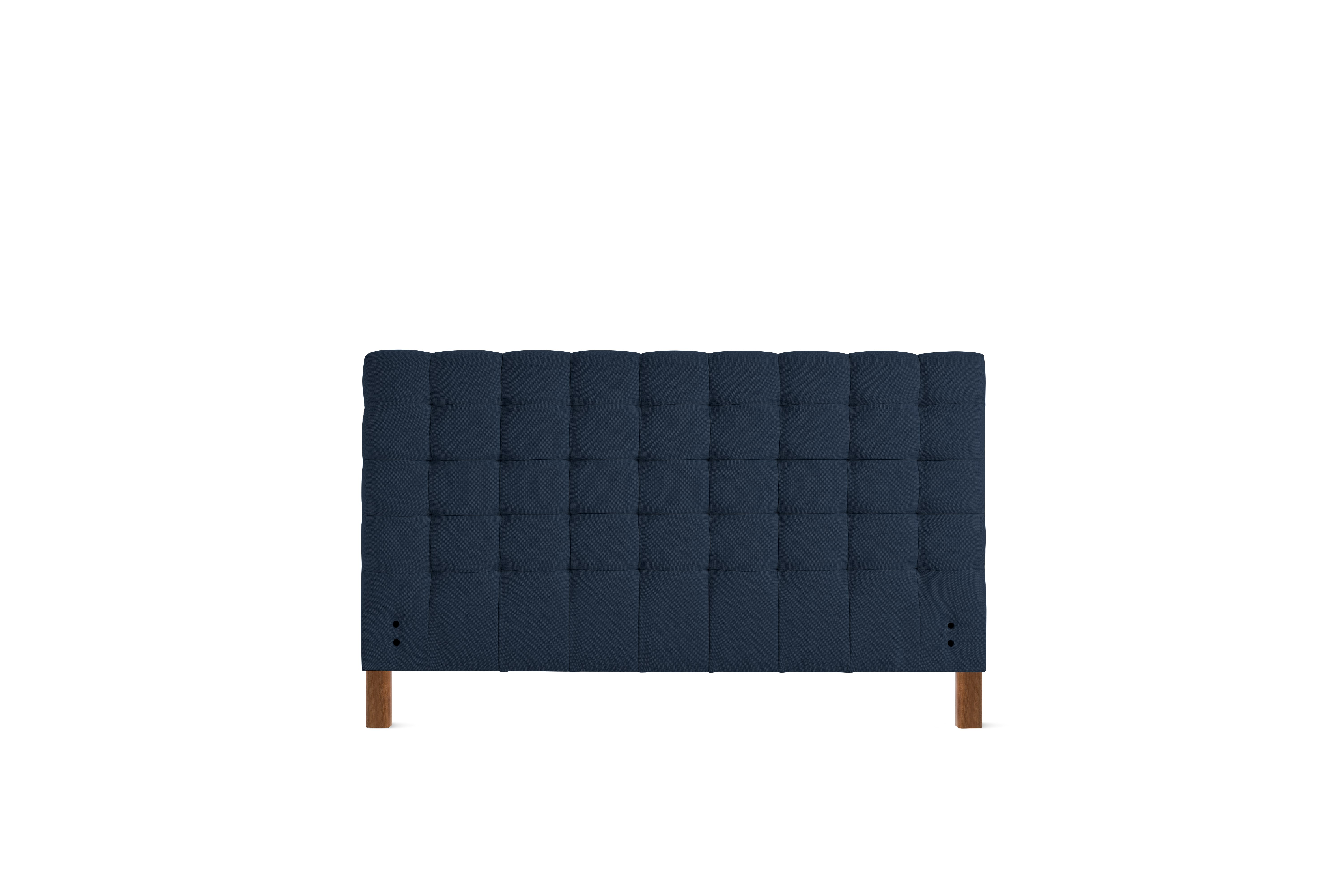 A Madeleine Headboard in Mode, Society, Walnut viewed from the front.