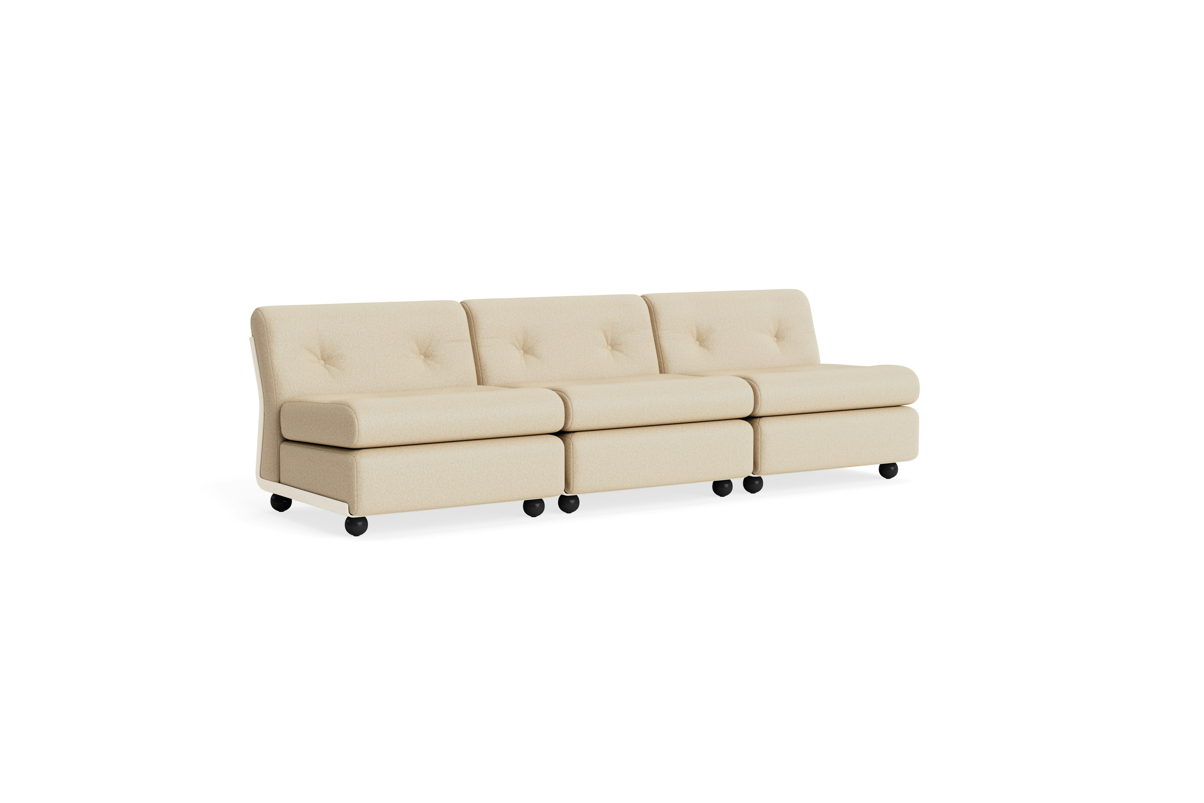 Three-seat beige upholstered Amanta sofa with sculpted backrest and black legs, angled left.