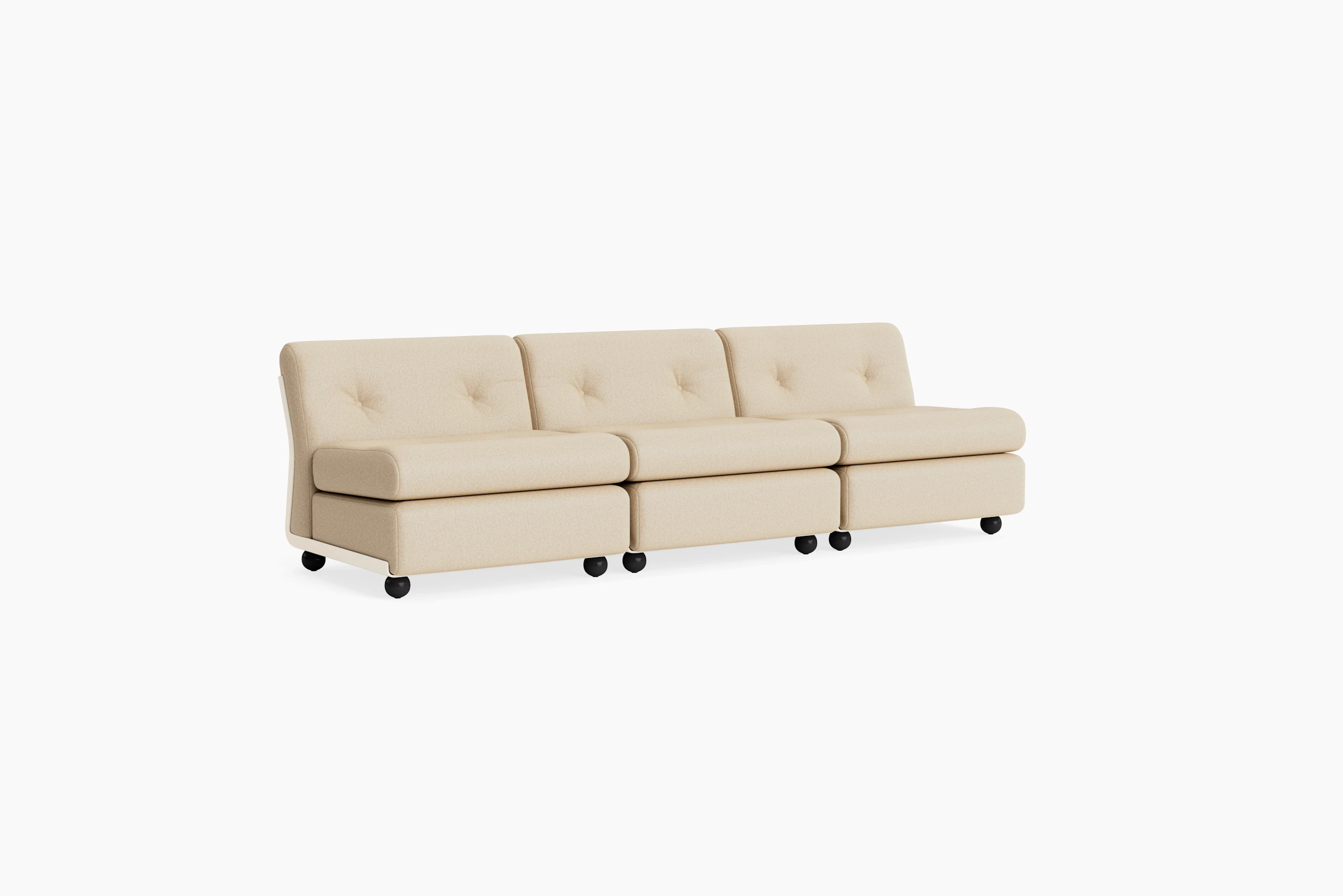 Three-seat beige upholstered Amanta sofa with sculpted backrest and black legs, angled left.