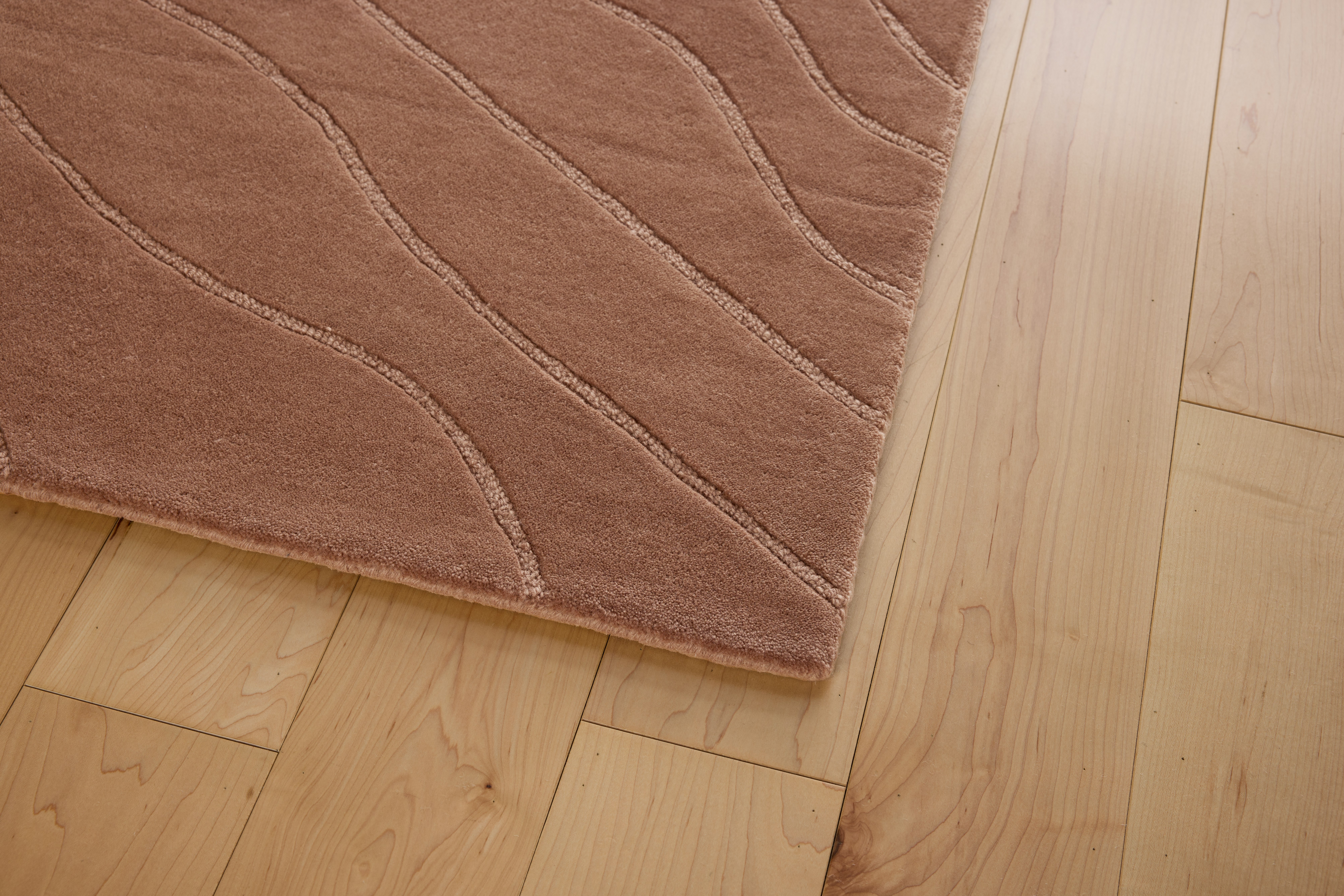 A detail view of a Waves Rug in Mocha.