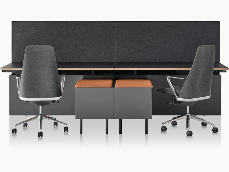 A Geiger One Casegoods bench system with two workstations, both with Taper Chairs and freestanding credenzas with seat pads.