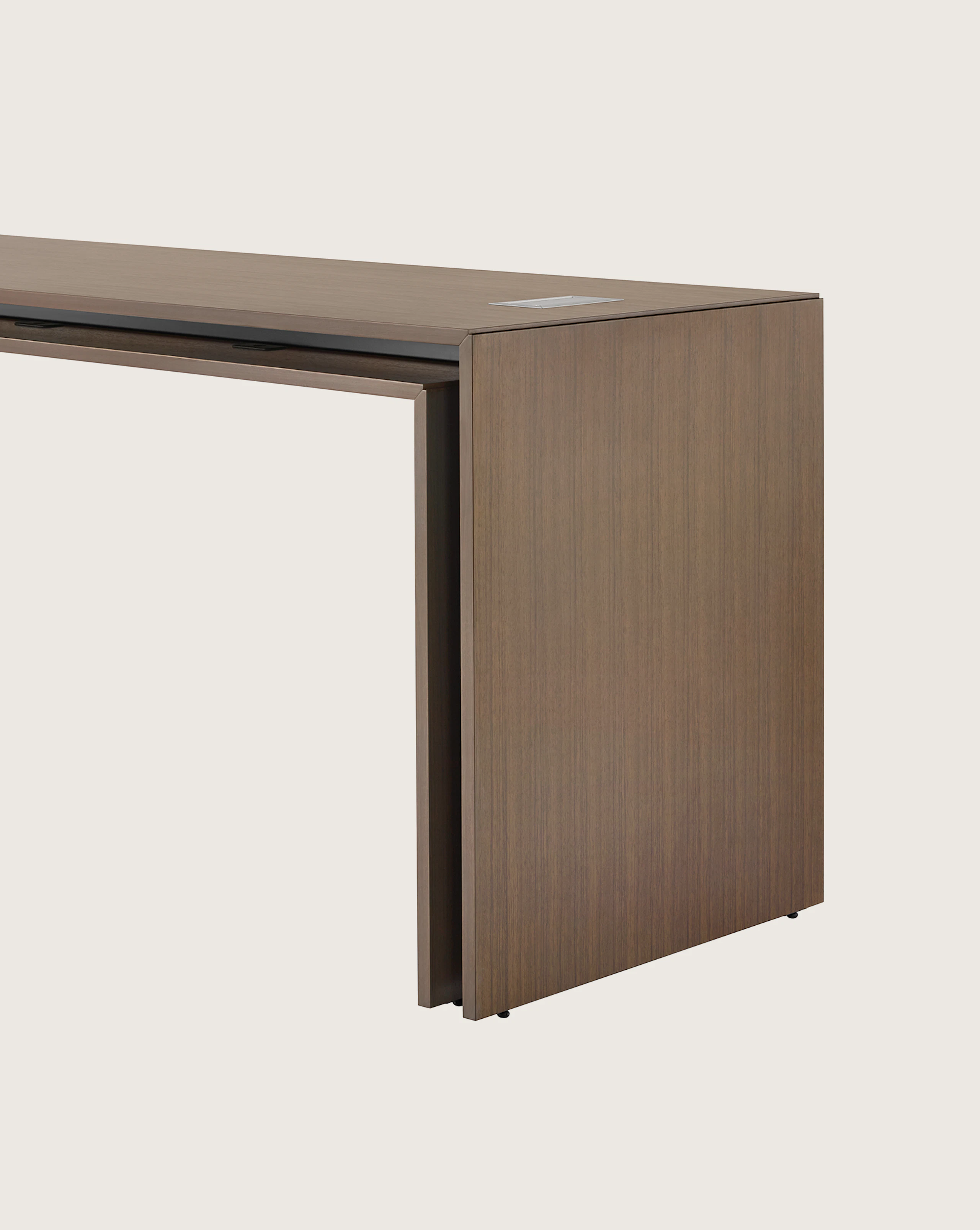 A rectangular Peer Table in a dark wood finish, viewed at an angle.