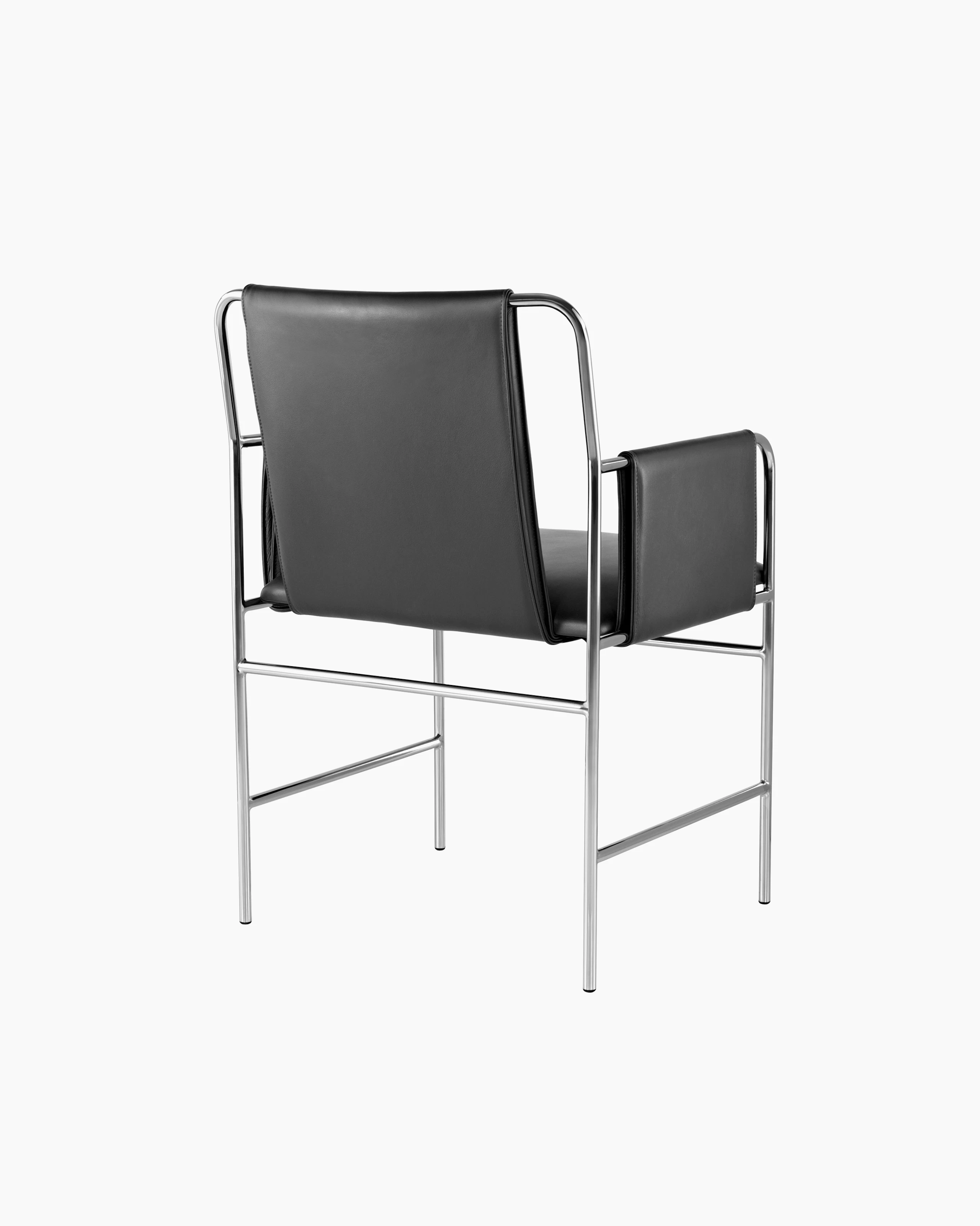 An Envelope side chair with black leather upholstery and a tubular steel frame, viewed from behind at an angle.