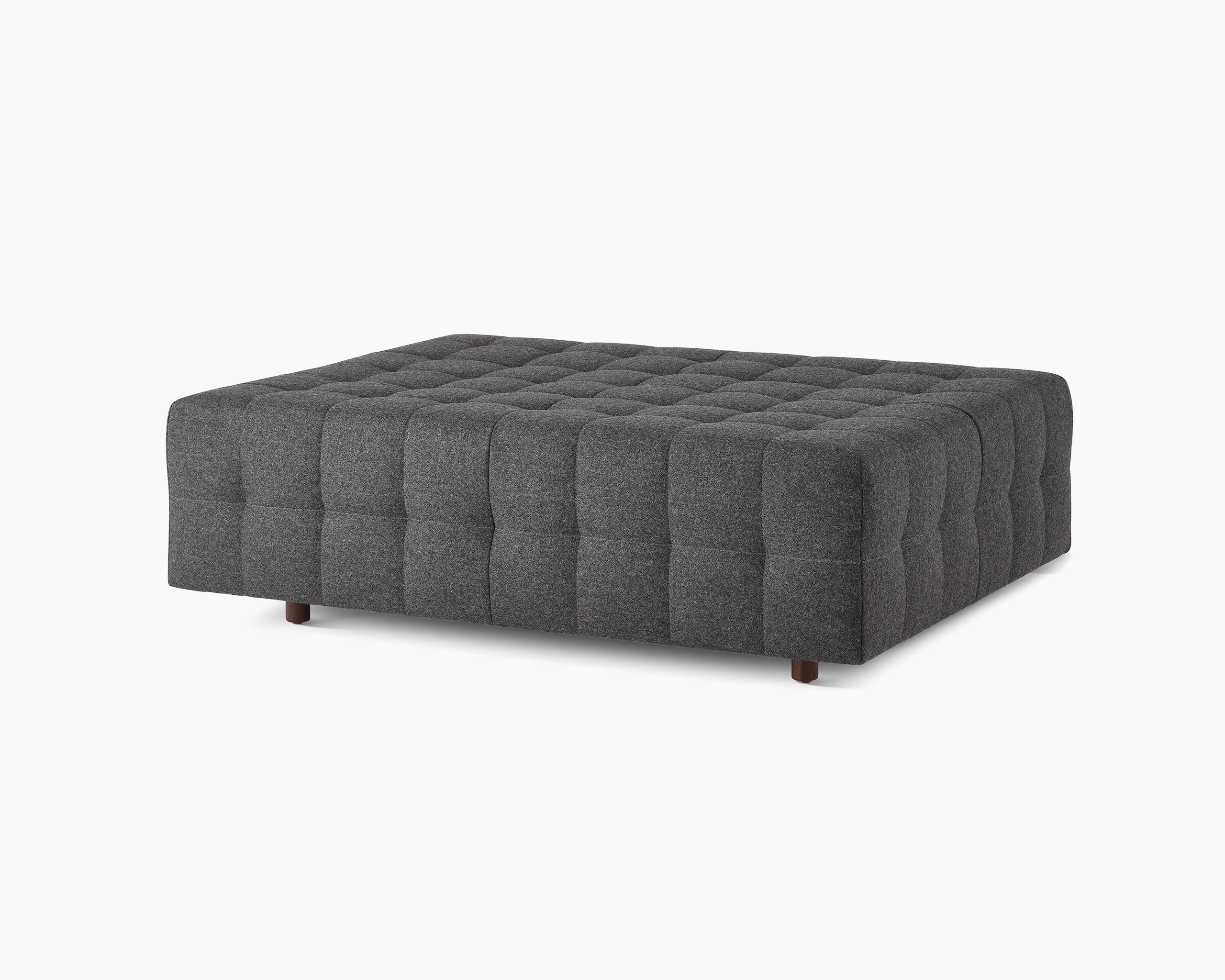 A Rapport ottoman upholstered in a dark grey fabric.