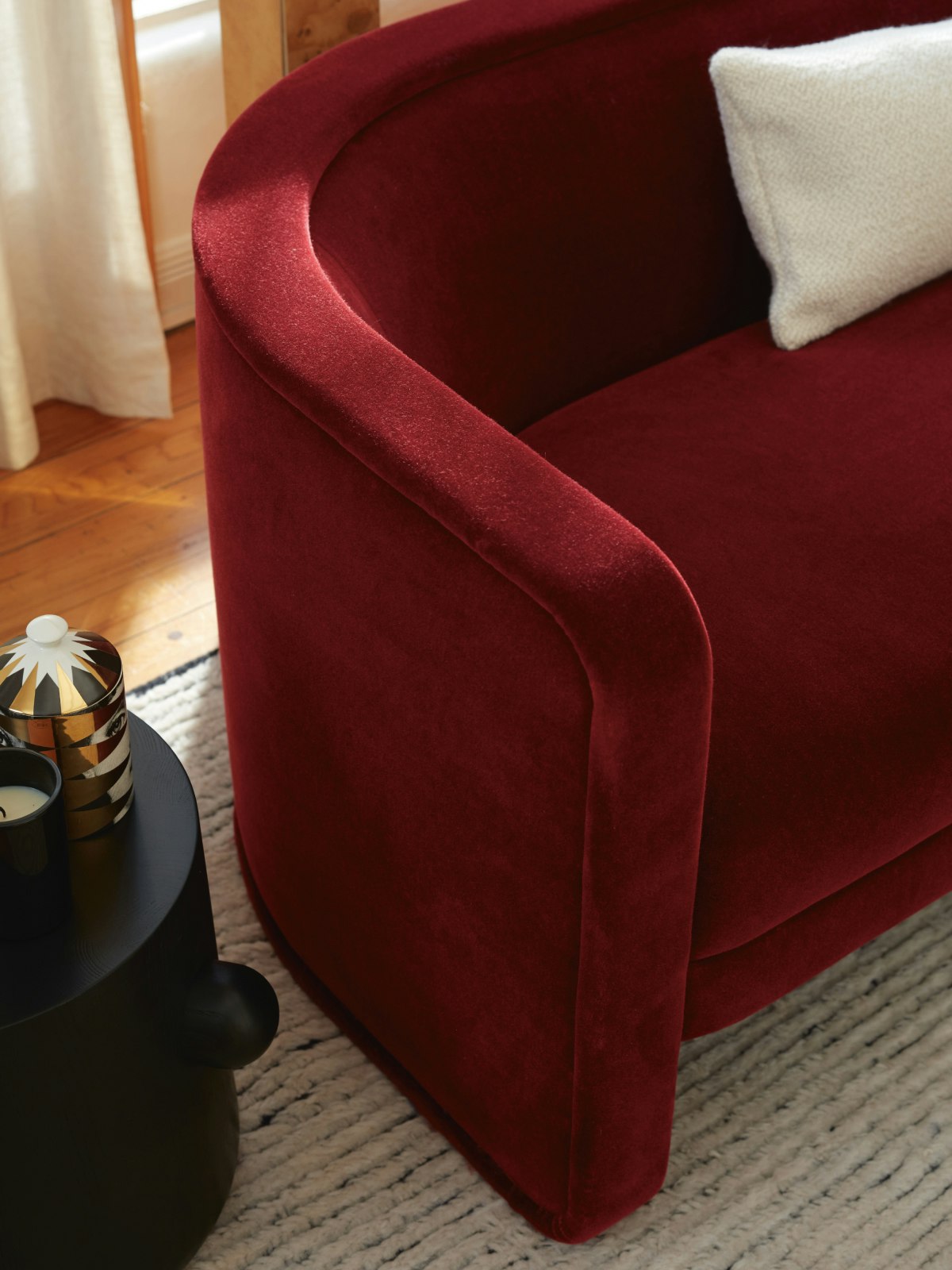 View of the corner of a U-Series Sofa in dark red.