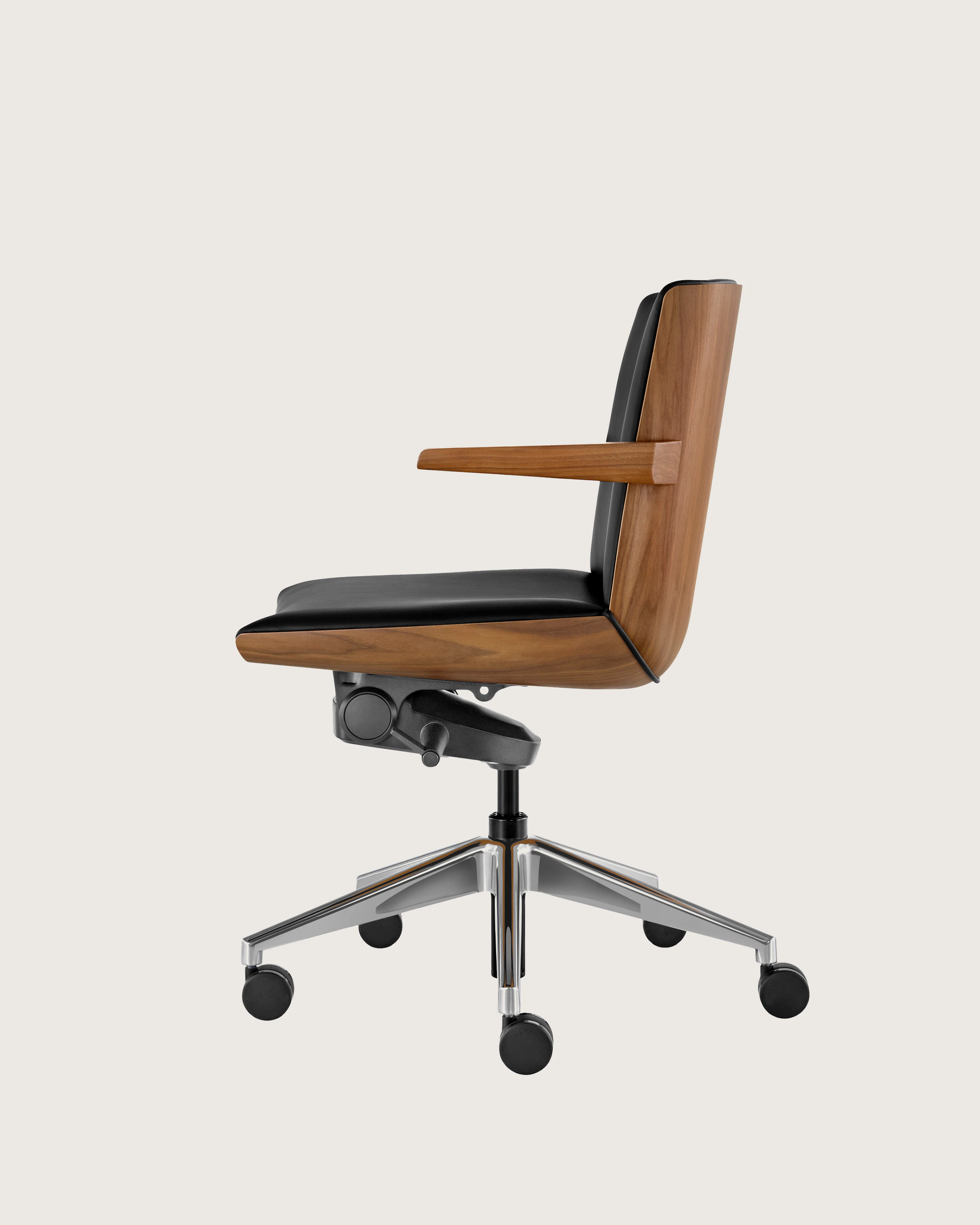 Profile view of a low-back Clamshell Conference chair with black leather upholstery, a walnut shell, with arms.