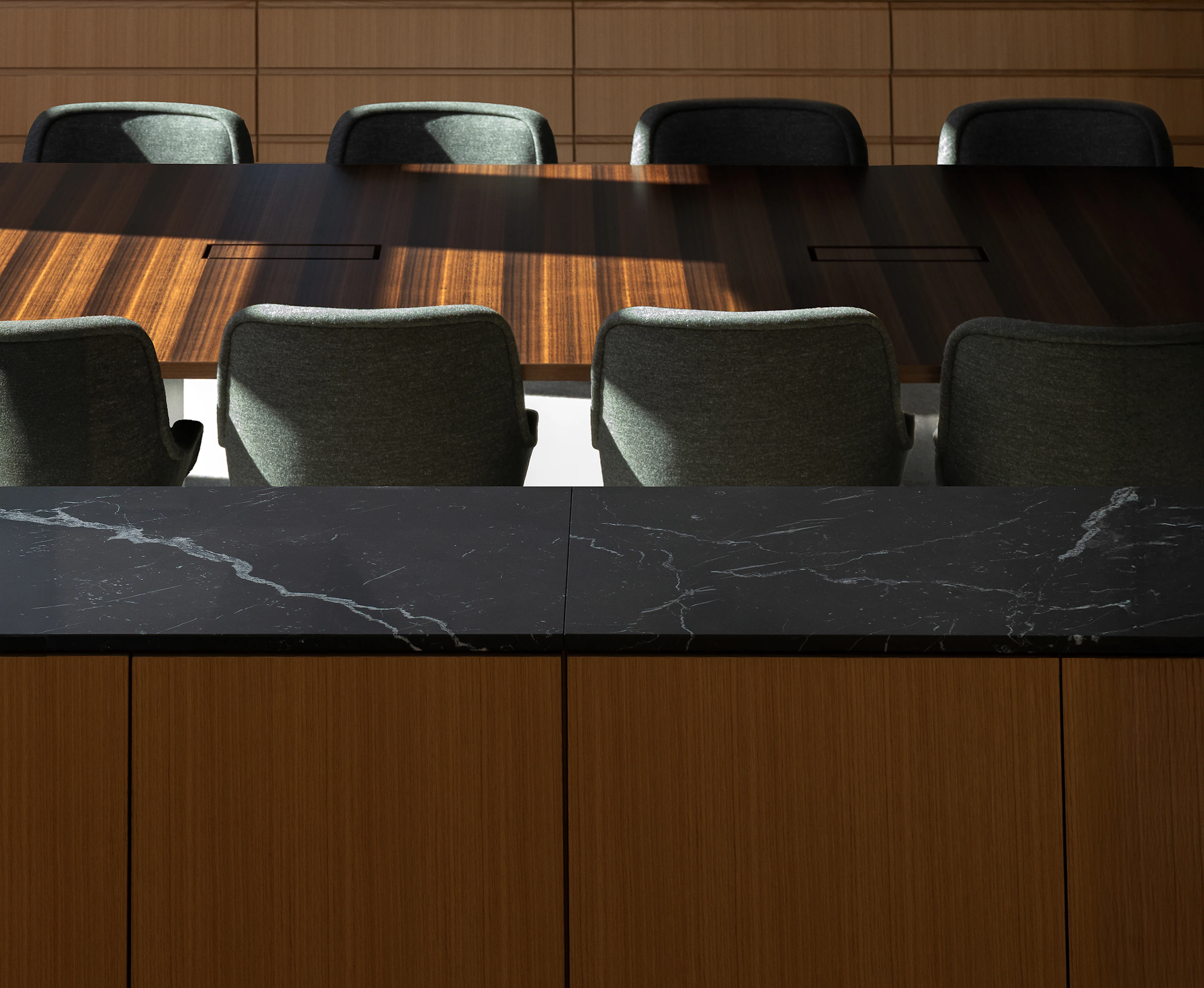 Bumper Conference Chairs with low arms upholstered with Bellano Black Green around a JD Conference Table in Fumed Quarter Cut Eucalyptus.