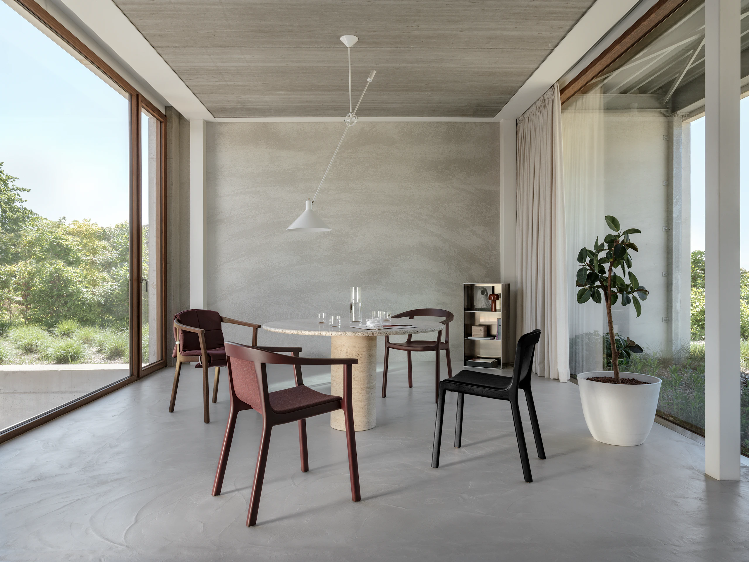 Three Lijn Armchairs in various configurations and one Lijn Side Chair around a dining room table in a residential setting.