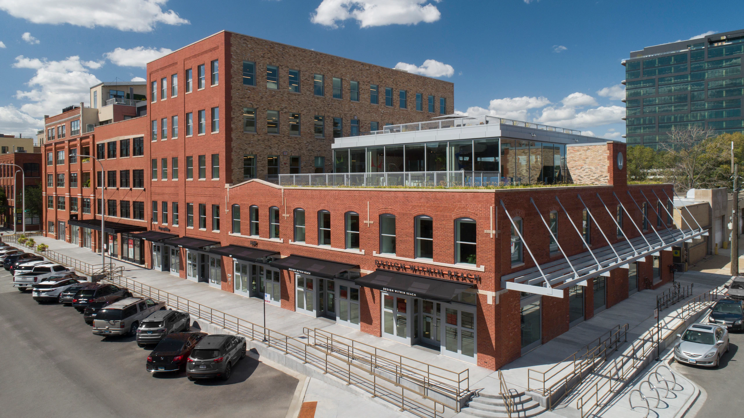 An angle view of the red-brick MillerKnoll Showroom at 1100 W. Fulton Market in Chicago on a sunny afternoon.