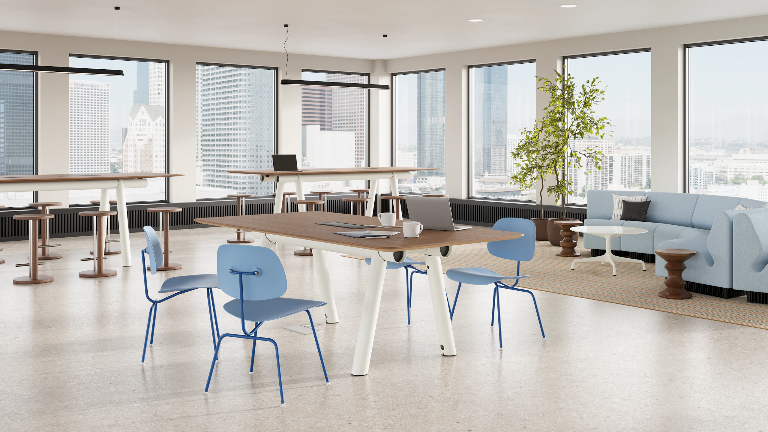 Boa Table in a work cafe setting with rectangle walnut top, and white base.
