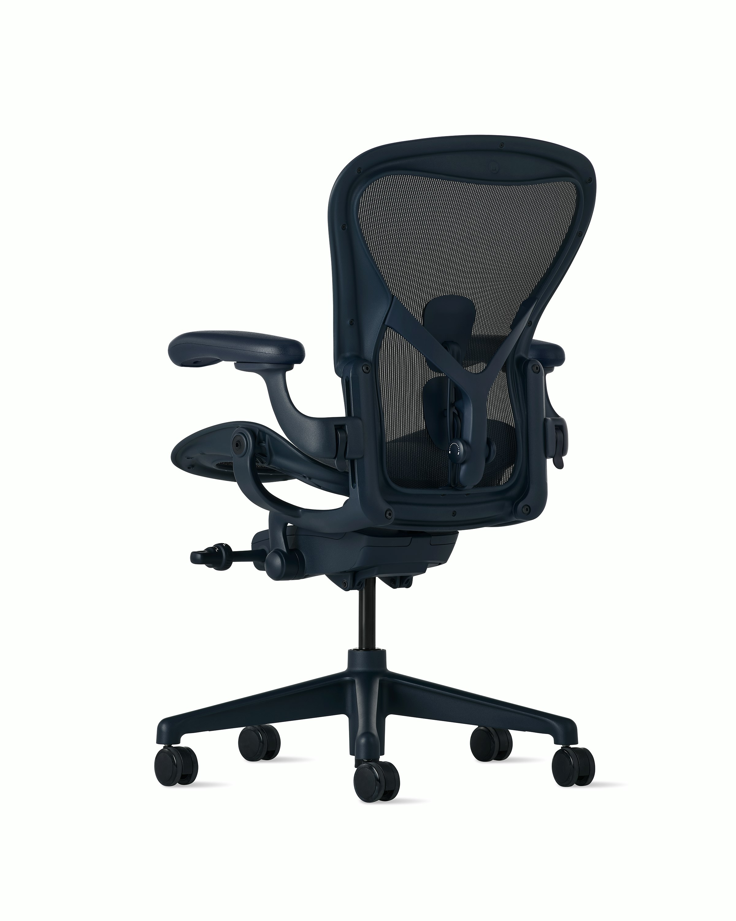 Rear angle view of an Aeron chair in navy with PostureFit SL. 