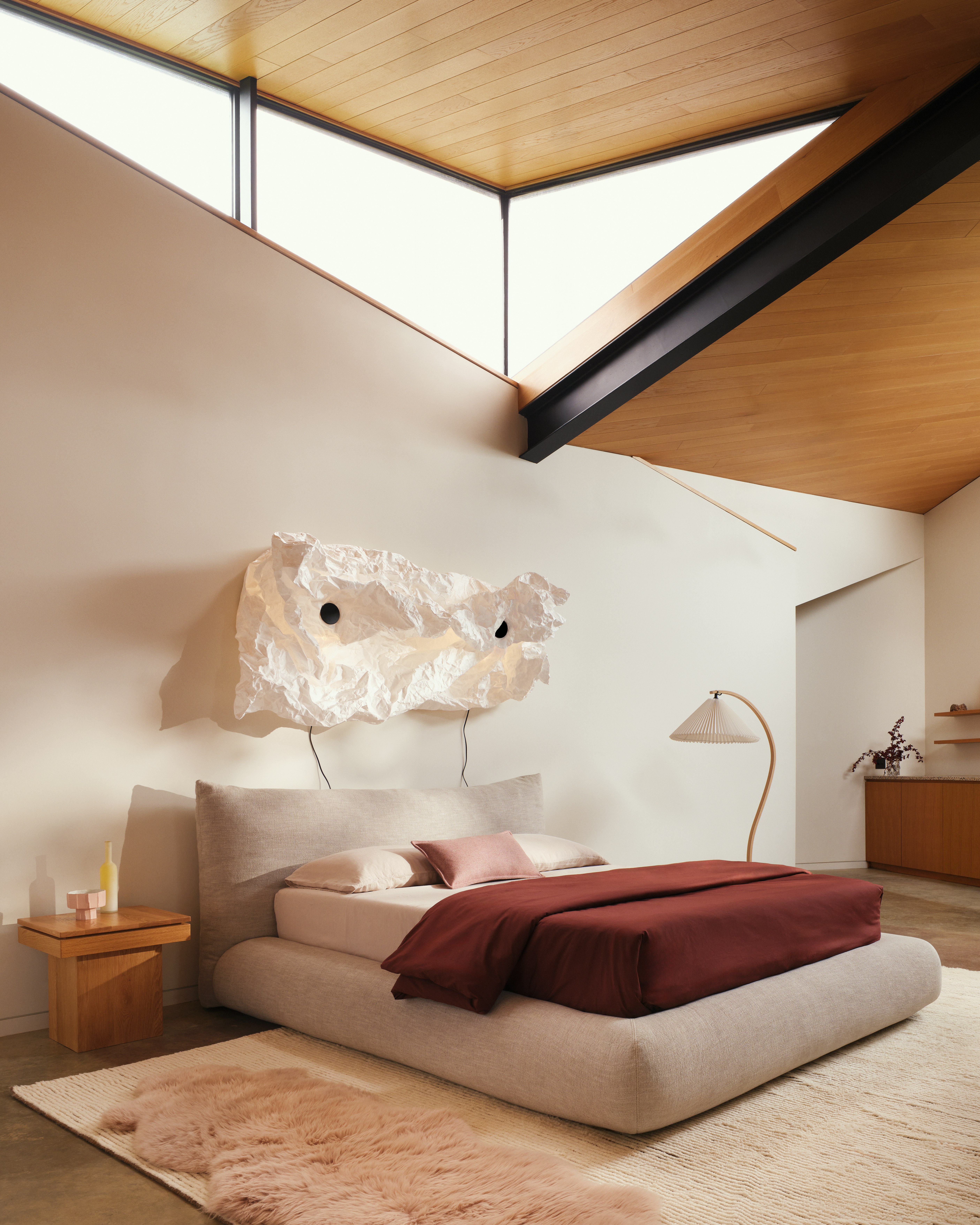 Pillo Bed in sand linen with Maap wall light in a bedroom