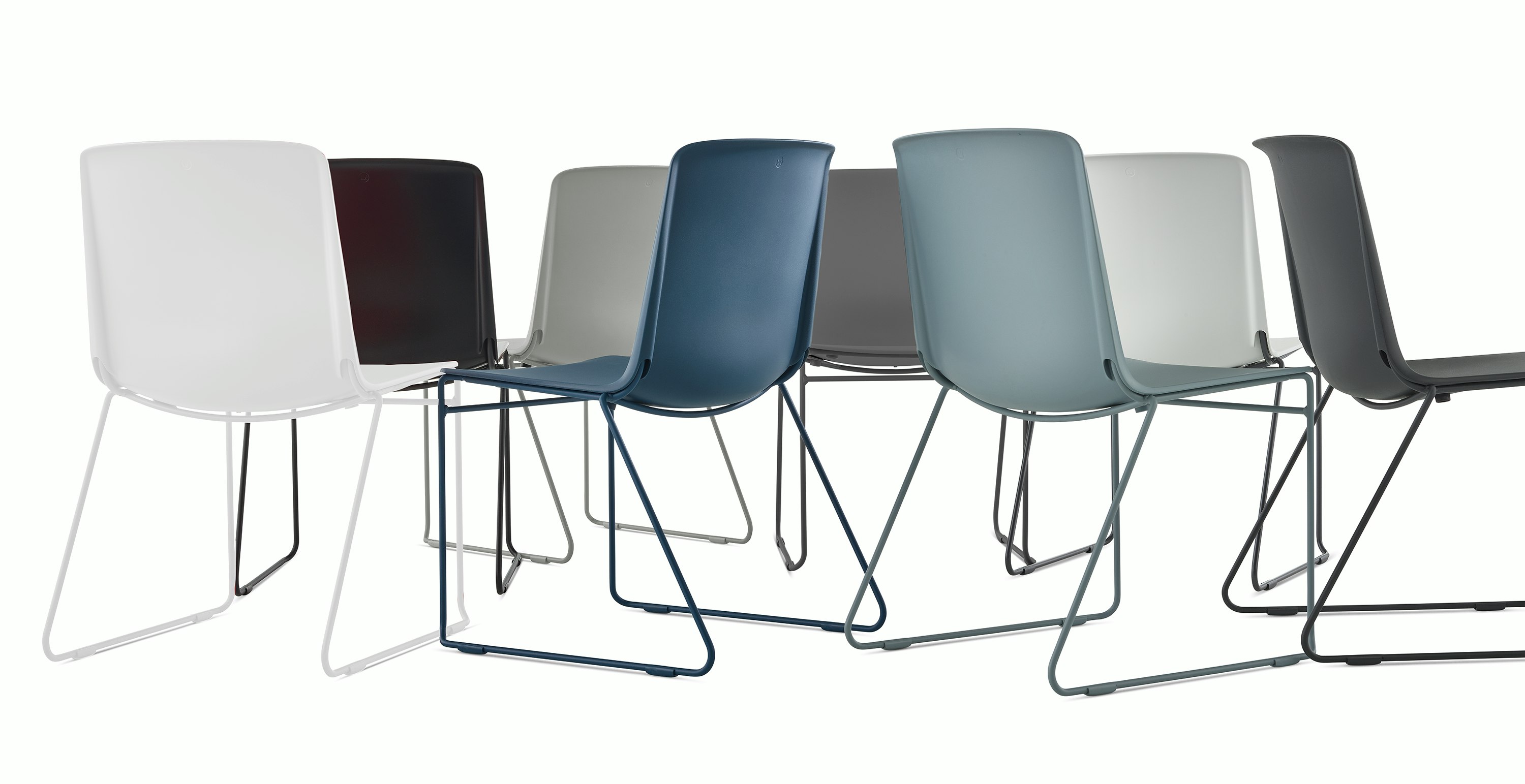 A group of multi colored Pronta Stacking Chairs.